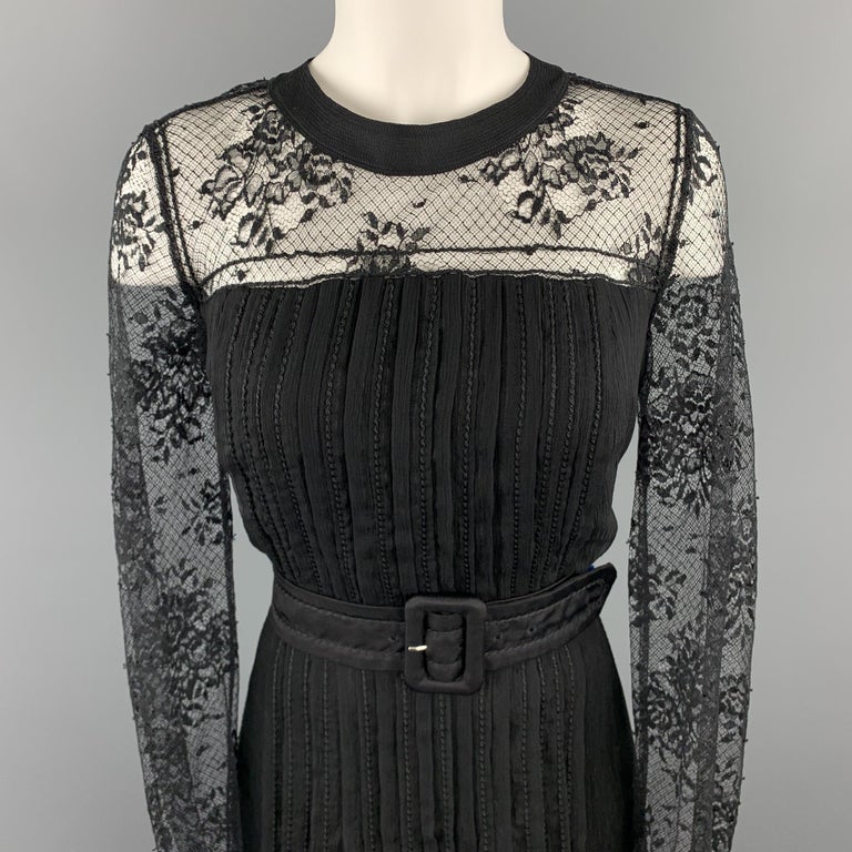 PRADA cocktail dress comes in black pleated silk crepe chiffon with top stitching throughout, belted waist, lace long sleeve top, and tied back neck. Made in Italy.

Excellent Pre-Owned Condition.
Marked: IT 46

Measurements:

Shoulder: 14 in.
Bust: