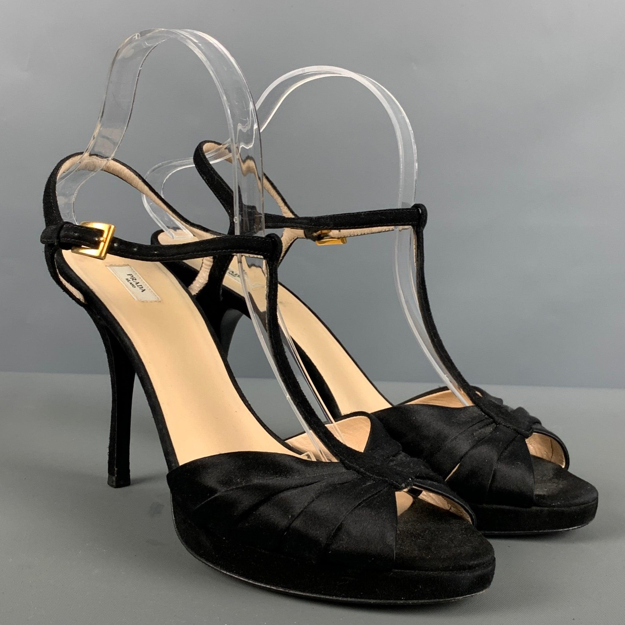 PRADA sandal heels comes in a black suede featuring a T-ankle strap, peep toe, and a stiletto heel. Made in Italy.Very Good Pre-Owned Condition. Minor signs of wear. 

Marked:   40 

Measurements: 
  Heel: 5 inches  
  
  
 
Reference:
