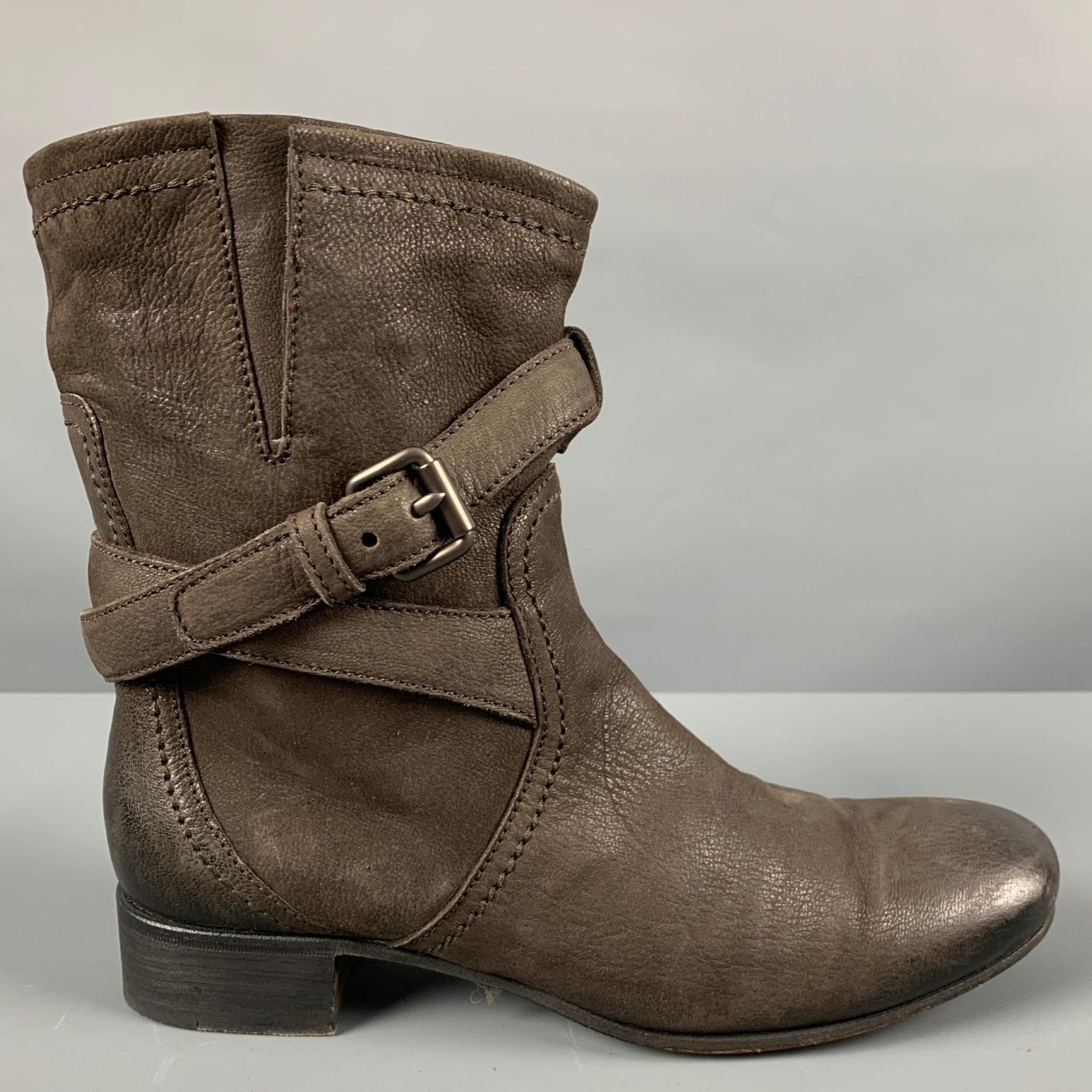 PRADA
boots in a brown leather featuring an ankle strap with gunmetal tone hardware. Made in Italy.Very Good Pre-Owned Condition. Moderate signs of wear. 

Marked:   40 

Measurements: 
  Length: 10.5 inches Width: 3.25 inches Height: 9 inches 
  
 