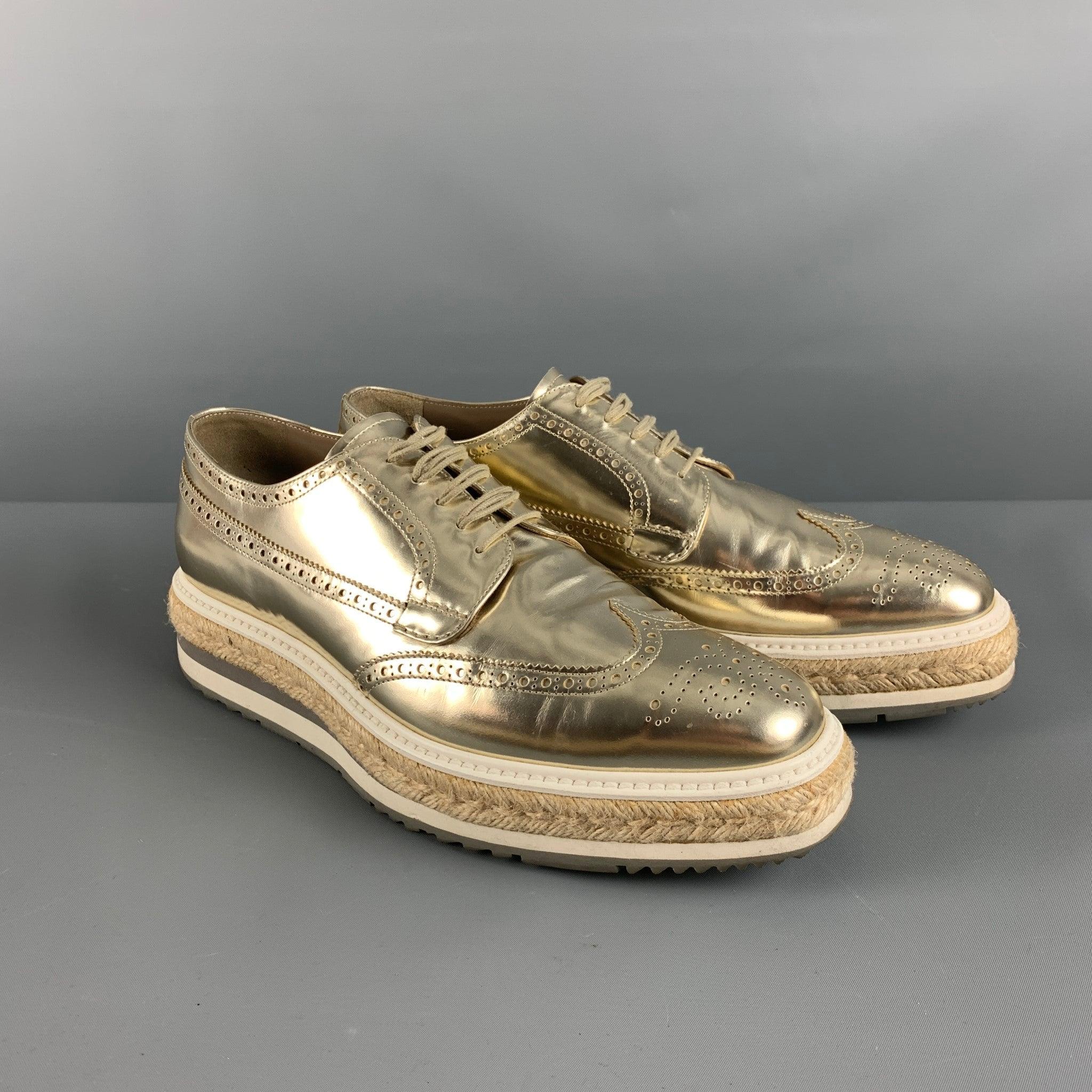 PRADA shoes comes in a gold metallic perforated leather featuring a wing tip style, jute trim rubber platform, square toe, and a lace up closure. Made in Italy. Includes dust bag.Very Good Pre-Owned Condition. 

Marked:   2EG0159. Size 10Outsole: 12