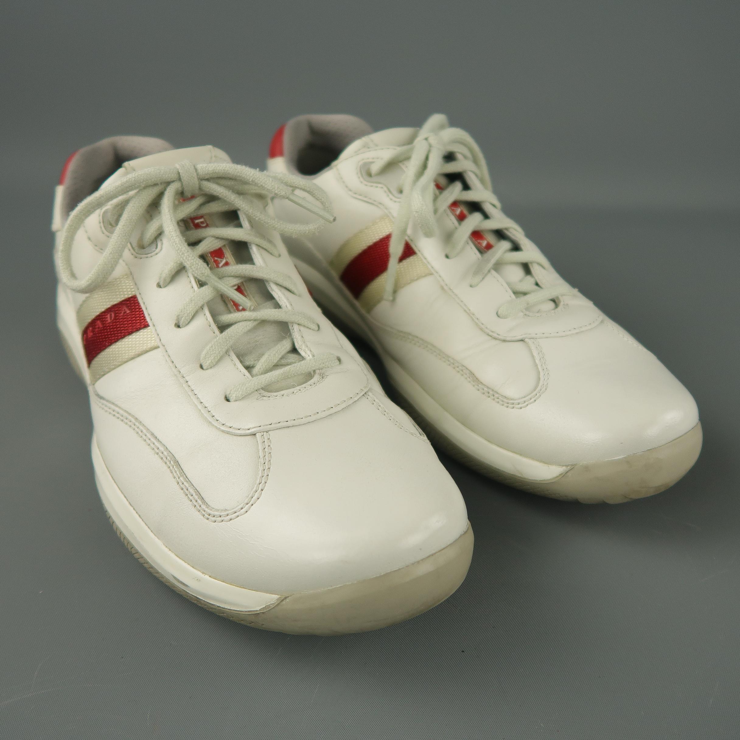 PRADA sneakers comes in a off white leather featuring a red trim detail and a rubber sole.
 
Very Good Pre-Owned Condition.
Marked: 9
 
Measurements:
 
Width: 4.5 in.
Length: 12 in.