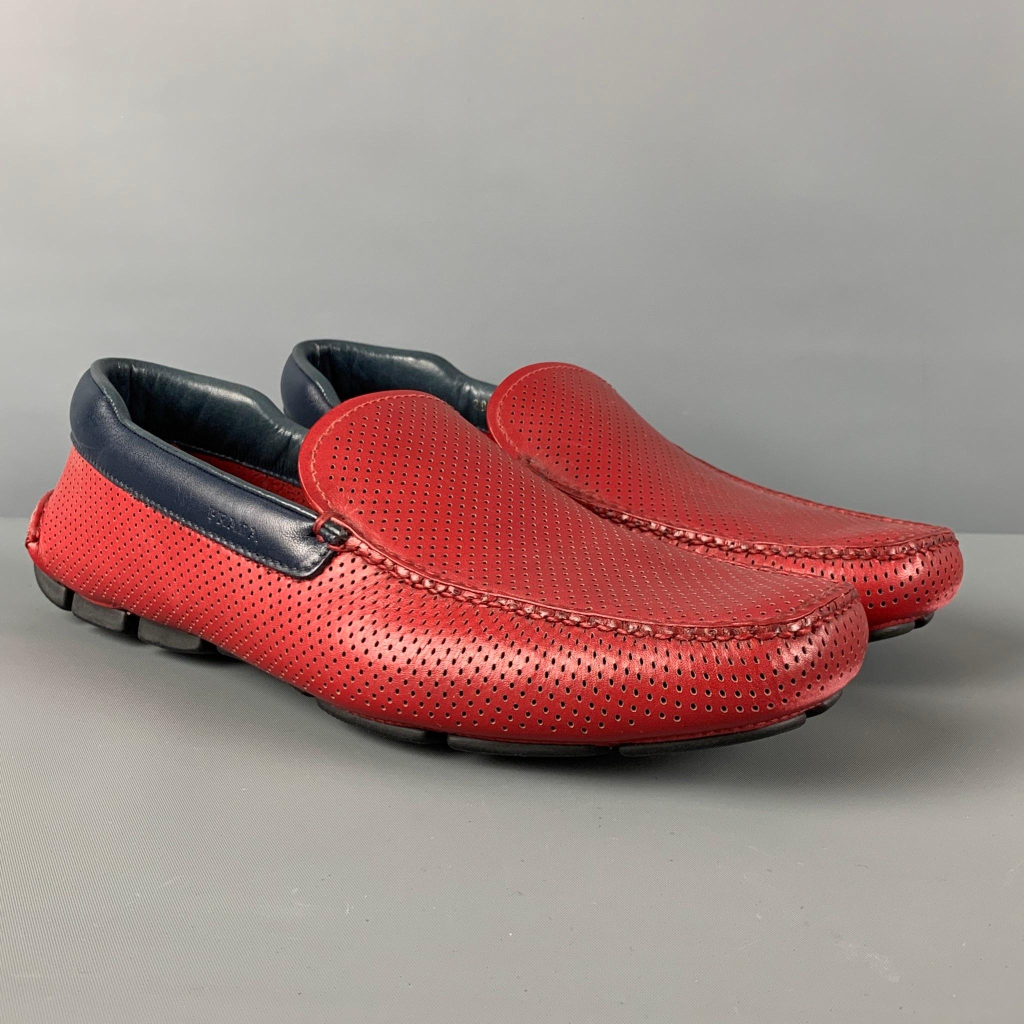 PRADA loafers comes in a red perforated leather featuring a drivers style, navy leather trim, and a square toe. 

Very Good Pre-Owned Condition.
Marked: 2DD115 9

Outsole: 12 in. x 4 in.