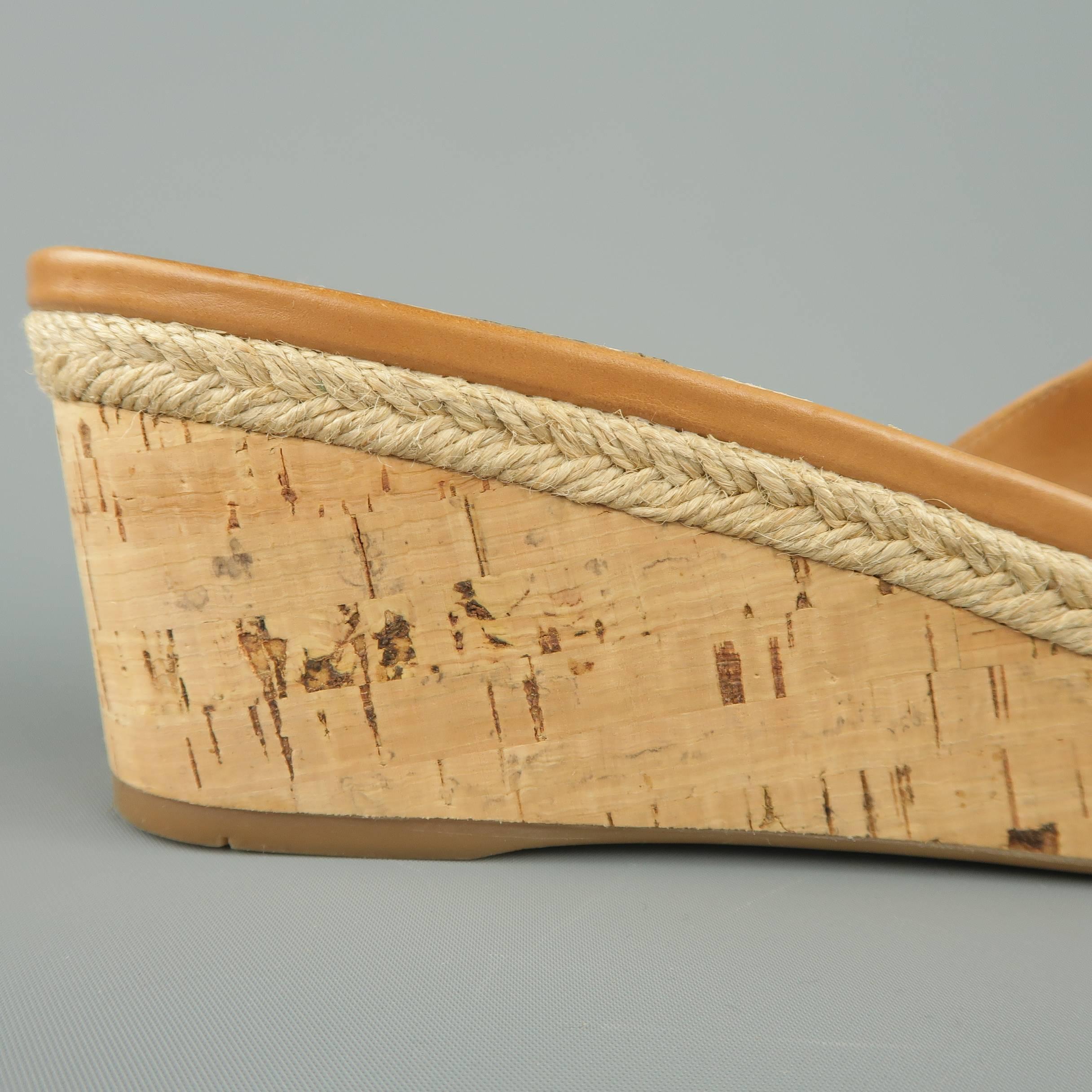 Classic PRADA mules feature a tan X strap and platform cork wedge with braided espadrille detail. Made in Italy.
 
Good Pre-Owned Condition.
Marked: IT 40
 
Measurements:
 
Heel: 2.5 in.
Platform: 1 in.
