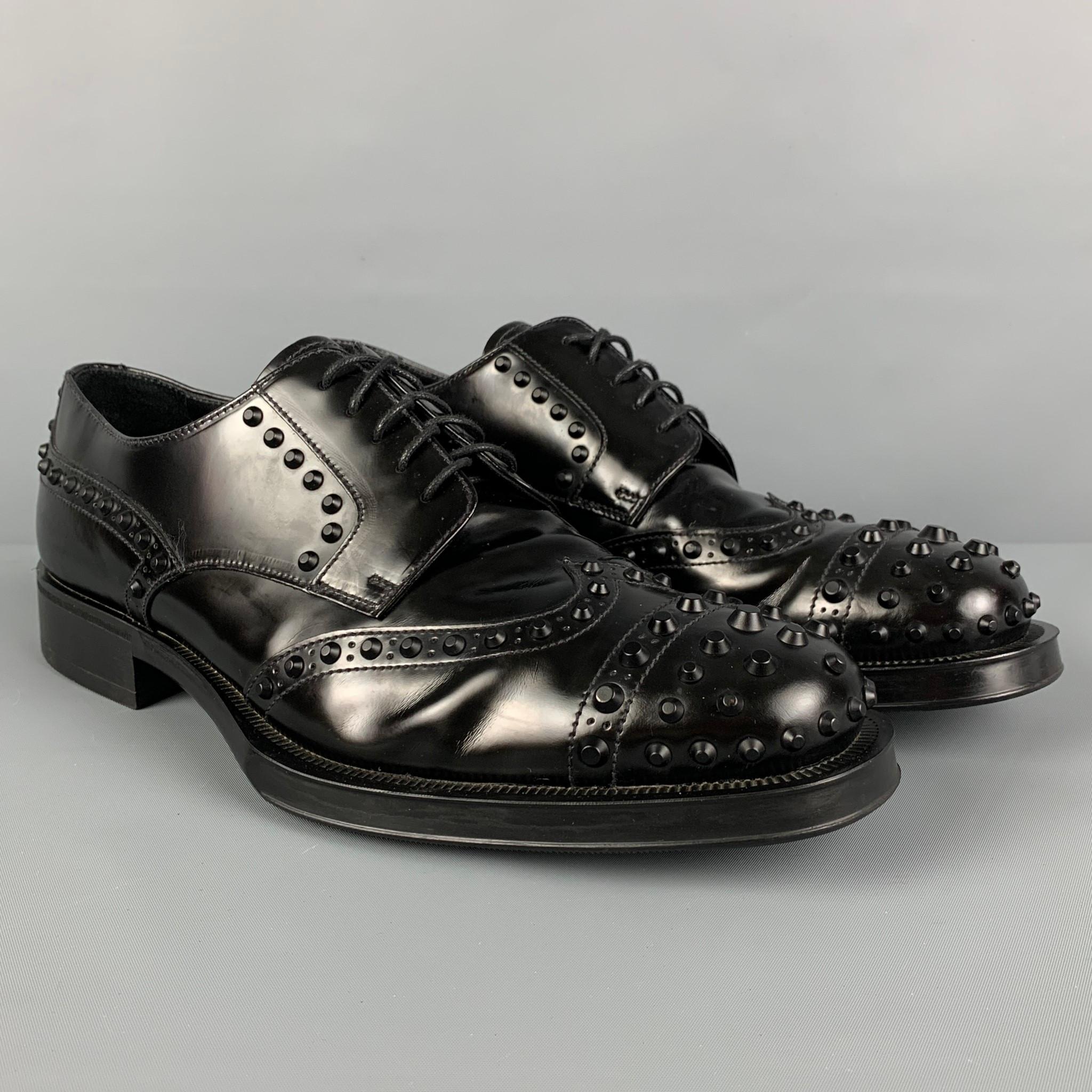 PRADA shoes comes in a black leather featuring studded details, cap toe, and a lace up closure. Made in Italy. 

Very Good Pre-Owned Condition. Light wear.
Marked: 2EE289 9.5

Outsole: 12.25 in. x 4.5 in. 