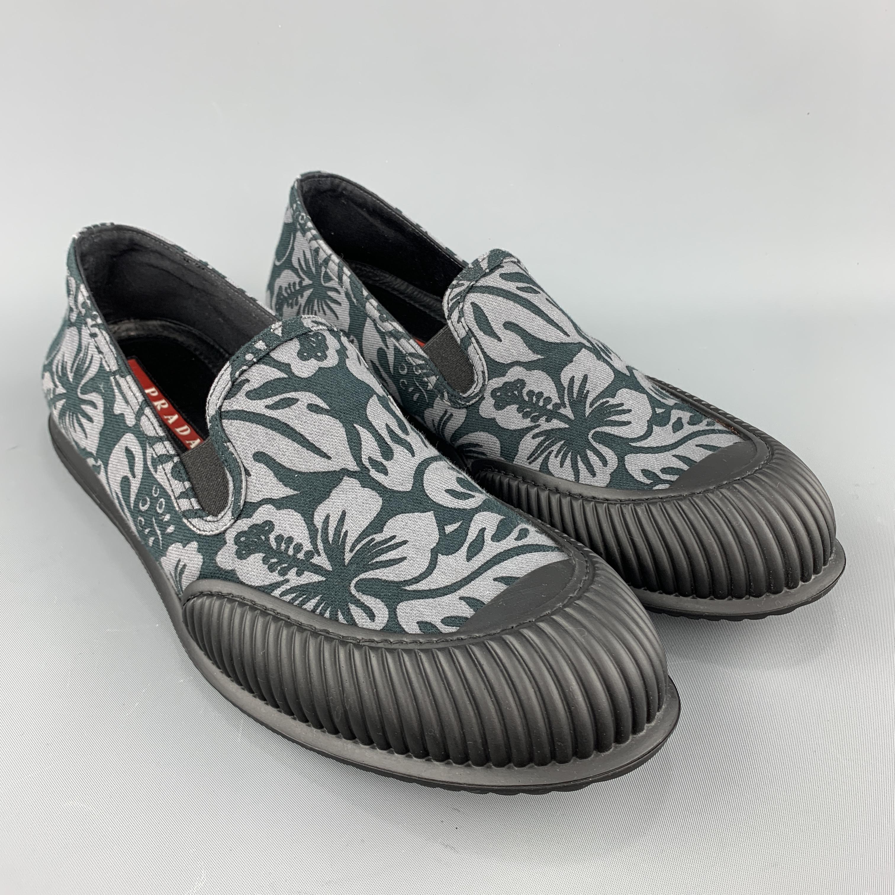 PRADA slip-ons come in navy and gray Hawaiian floral print canvas with a textured rubber toe cap and sole. Made in Italy.
 
Excellent Pre-Owned Condition.
Marked: (no size)
 
Outsole: 12 x 4.5 in.