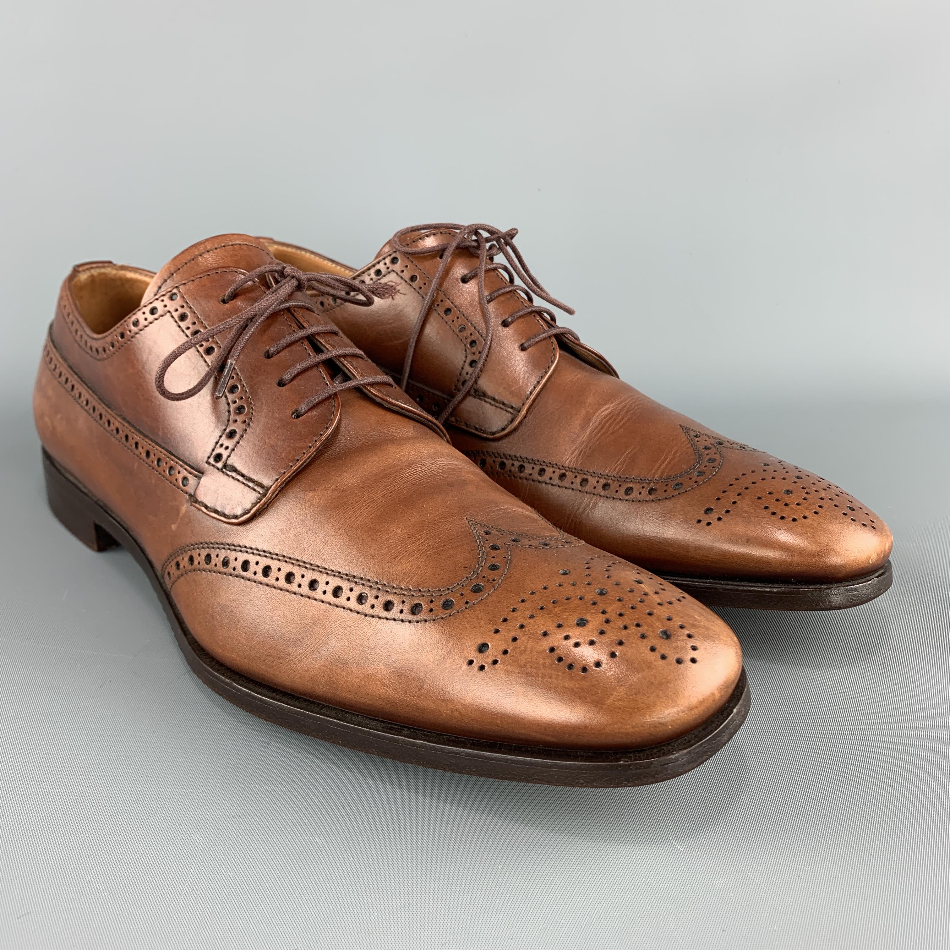 PRADA dress shoes come in tan leather with a wing tip, medallion, and perforated broguing throughout.  Made in Italy.

Very Good Pre-Owned Condition.
Marked: UK 9.5

Outsole: 12.25 x 4.25 in.