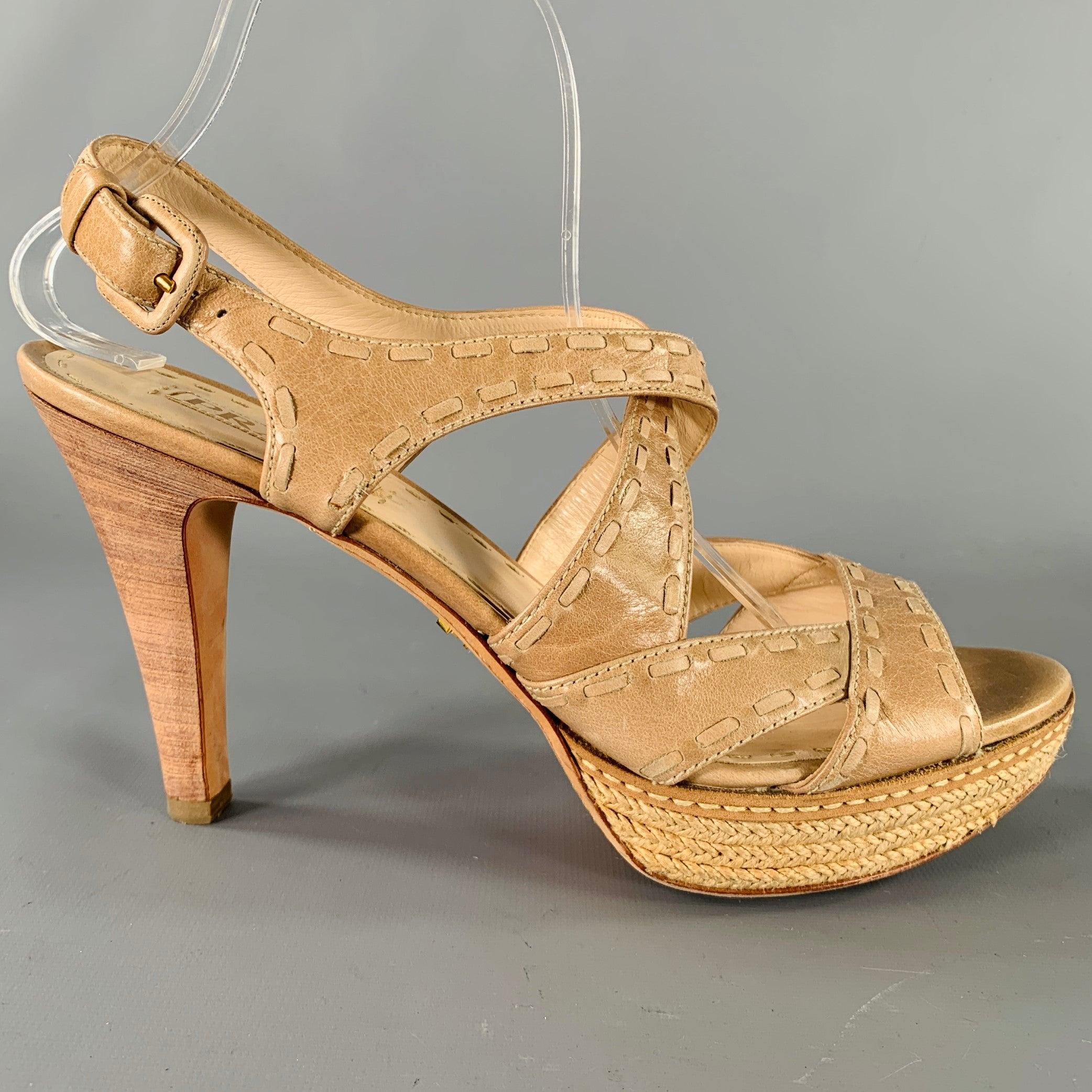 PRADA sandals
in a beige and taupe leather fabric featuring an espadrille platform style, woven design, and buckle closure. Made in Italy.Very Good Pre-Owned Condition. Minor signs of wear. 

Marked:   41 

Measurements: 
  Platform: 0.75 inches