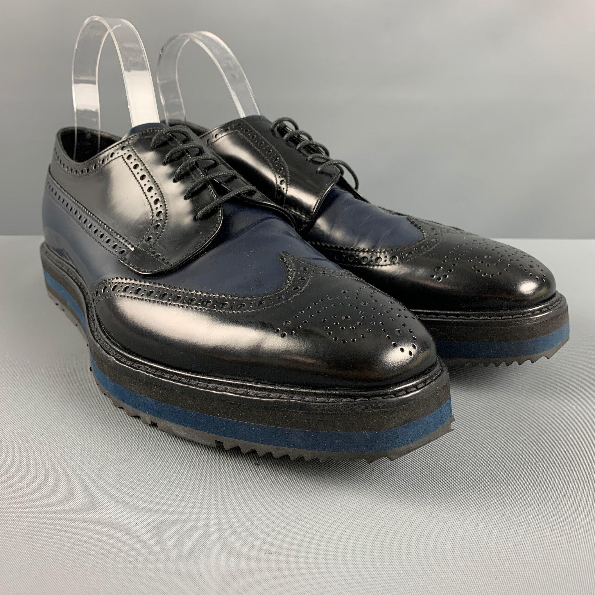 PRADA shoes comes in a black and navy perforated leather featuring a square toe, platform, rubber sole, and a lace up closure. Made in Italy.Excellent Pre-Owned Condition. Minor signs of wear. 

Marked:   2EG 015 10Outsole: 4.5 inches  x 13 inches 