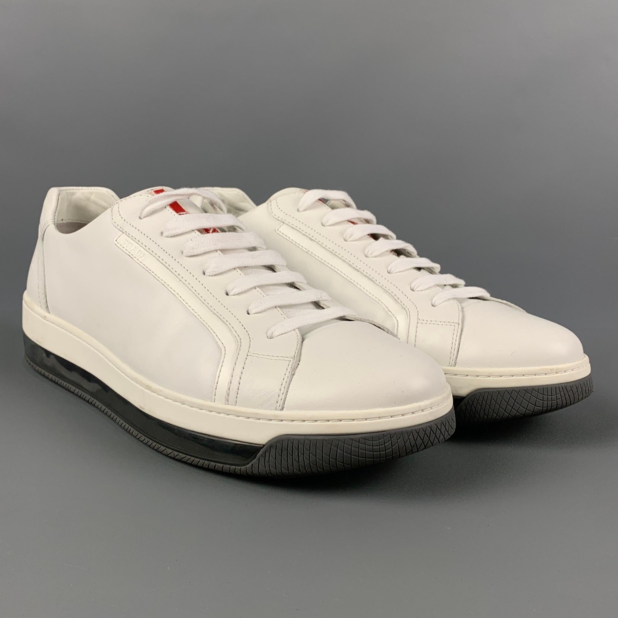 PRADA sneakers comes in a white leather featuring a low top style, transparent rubber sole, and a lace up closure. Includes box. 

Very Good Pre-Owned Condition.
Marked: 4E 2701 10.5
Original Retail Price: $690.00

Outsole: 12.25 in. x 4.25 in. 