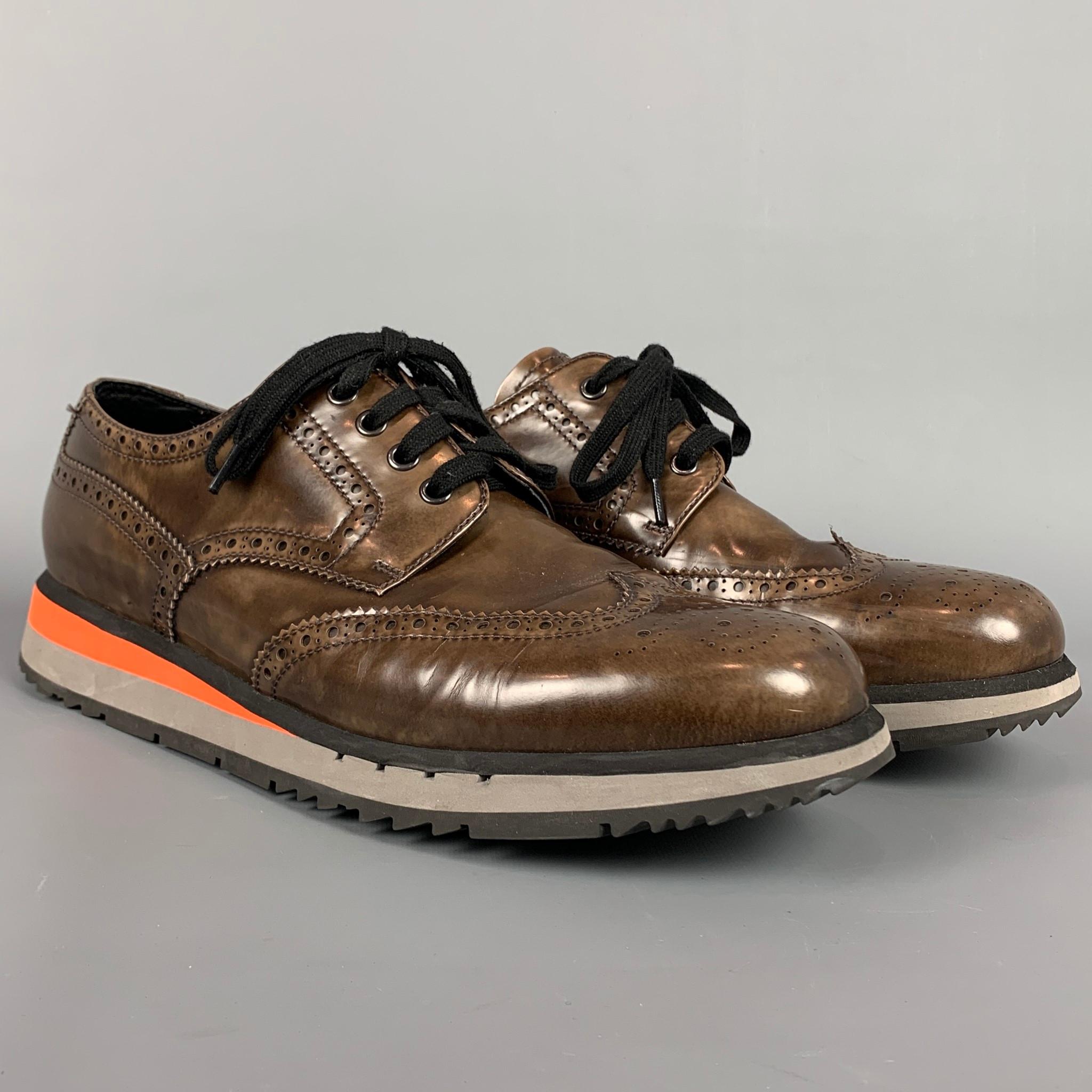 PRADA shoes comes in a brown perforated leather featuring a wingtip style, rubber sole, and a lace up closure. Includes box. 

Very Good Pre-Owned Condition.
Marked: 4E2339 11
Original Retail Price: $580.00

Outsole: 12.5 in. x 4.5 in. 