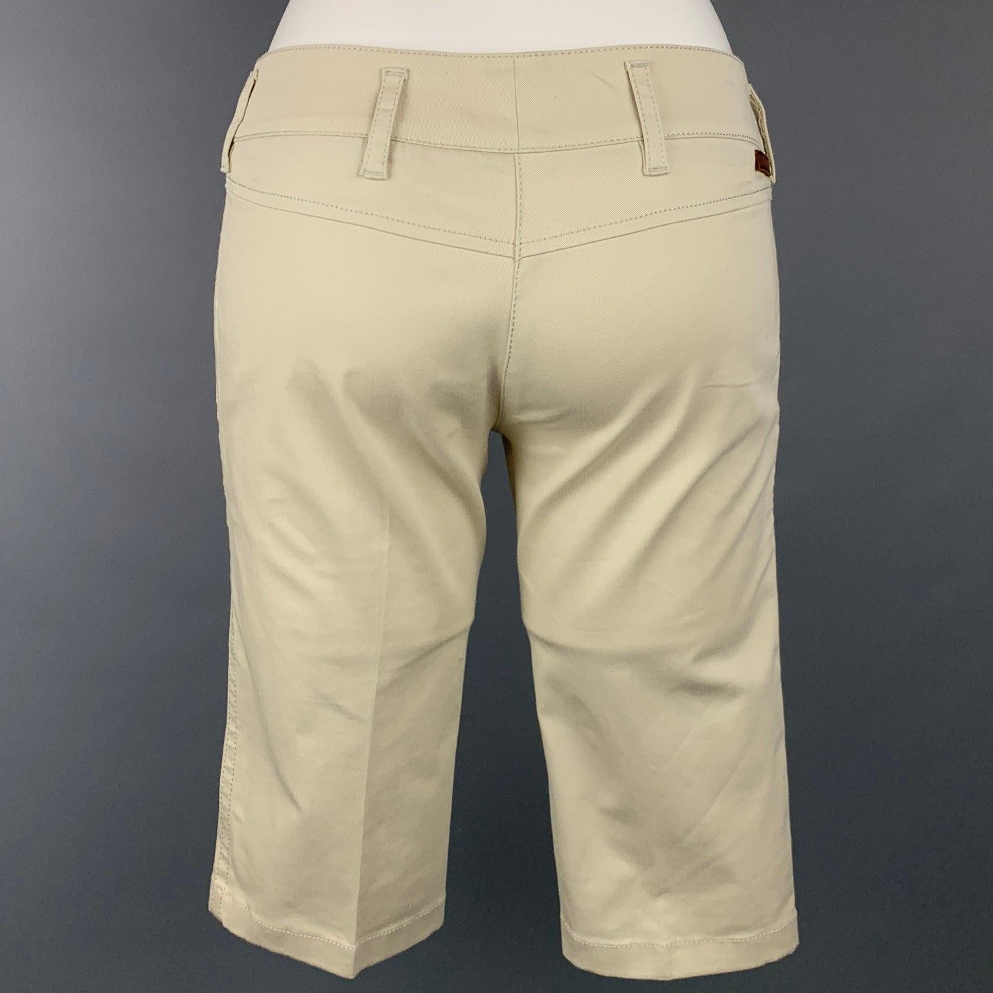 PRADA shorts comes in a beige cotton featuring a bermuda style, slit pockets, zip fly, and a double front tab closure.Very Good
Pre-Owned Condition. 

Marked:   38 

Measurements: 
  Waist: 30 inches  Rise: 7.5 inches  Inseam: 14 inches 
  
  
