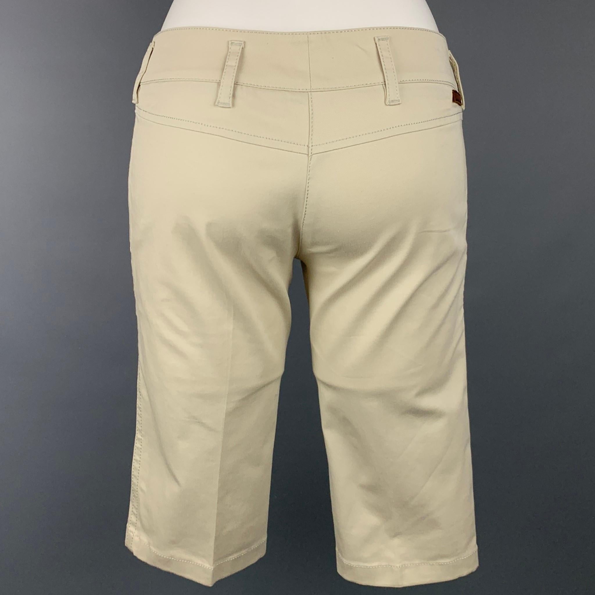 PRADA shorts comes in a beige cotton featuring a bermuda style, slit pockets, zip fly, and a double front tab closure.

Very Good Pre-Owned Condition.
Marked: 38

Measurements:

Waist: 30 in.
Rise: 7.5 in.
Inseam: 14 in. 