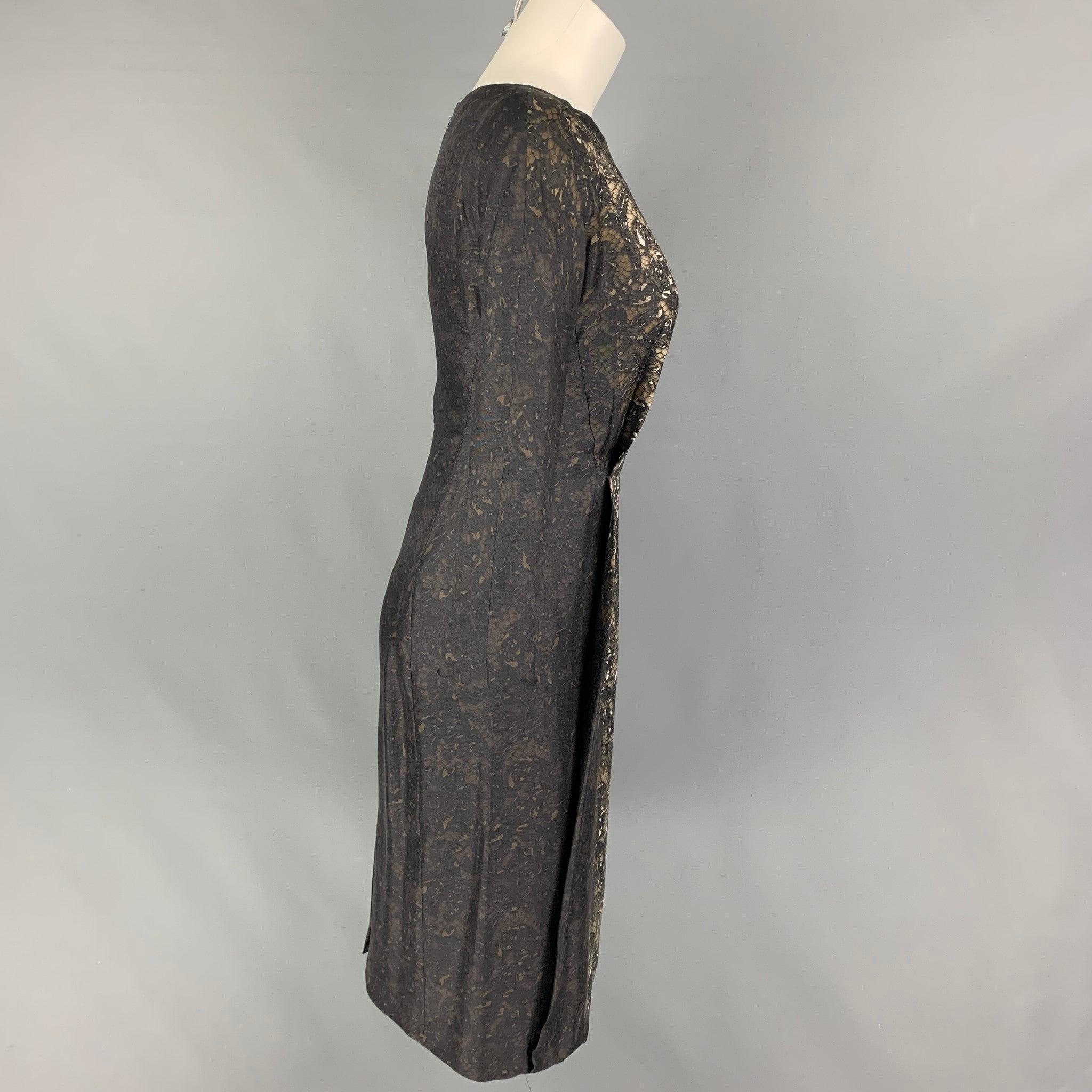 PRADA dress comes in a black & brown lace print silk featuring a a-line style, 3/4 sleeves, and a back zip up closure. Made in Italy.
Very Good
Pre-Owned Condition. 

Marked:   38 

Measurements: 
 
Shoulder: 16.5 inches  Bust: 32 inches  Waist: 26