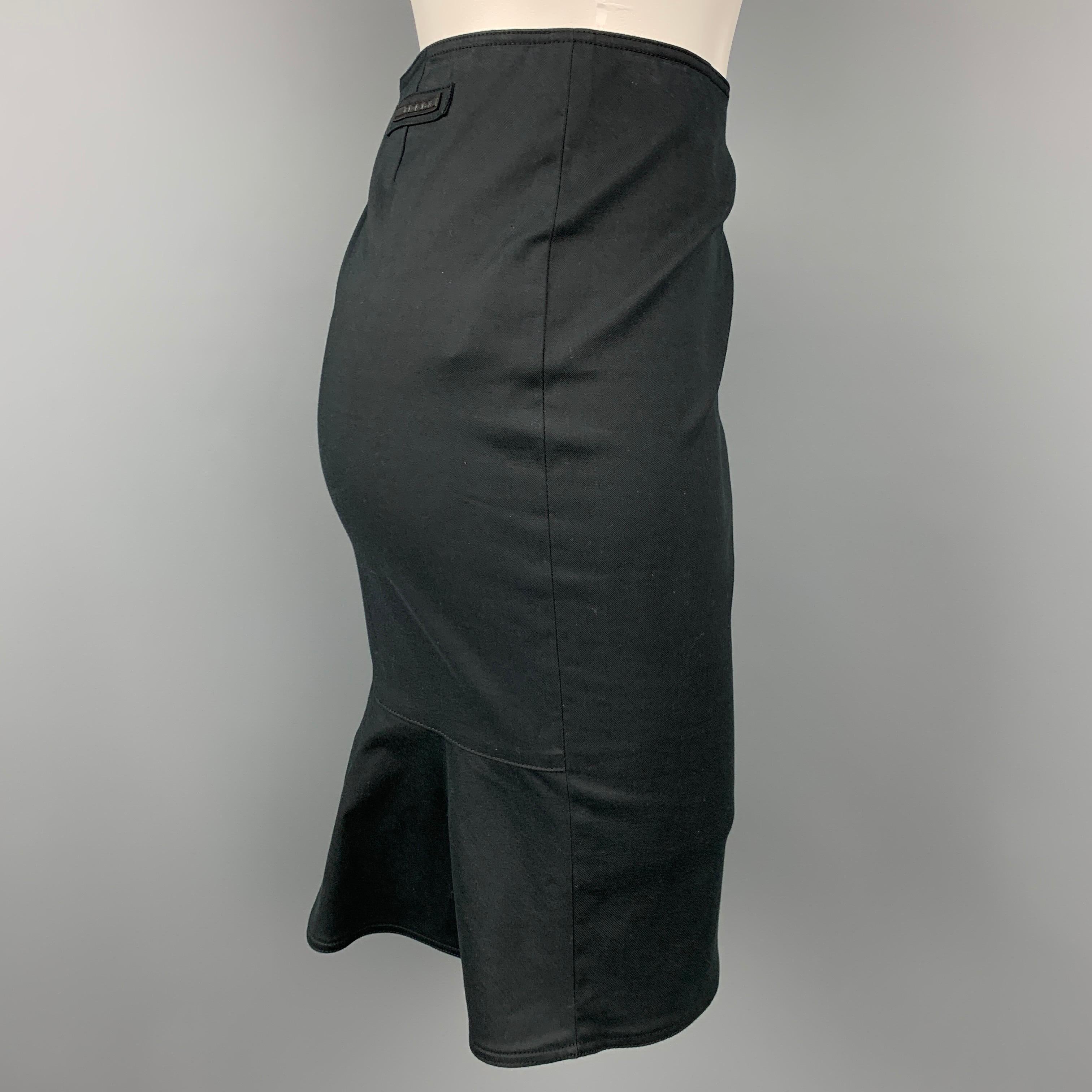 PRADA skirt comes in a black cotton featuring a flounce style, logo detail, and a front zipper closure. 

Very Good Pre-Owned Condition.
Marked: 38

Measurements:

Waist: 28 in.
Hip: 34 in.
Length: 19.5 in. 