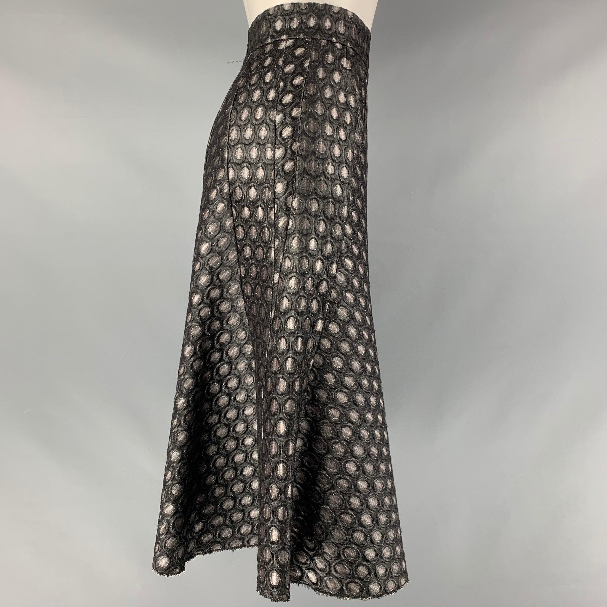 PRADA skirt comes in a silver and black acrylic blend dots jacquard featuring an a-line style and a center back invisible zip up closure. Made in Italy.Excellent Pre-Owned Condition. 
 

 Marked:  IT 38 
 

 Measurements: 
  Waist: 25 inches Hip: 38