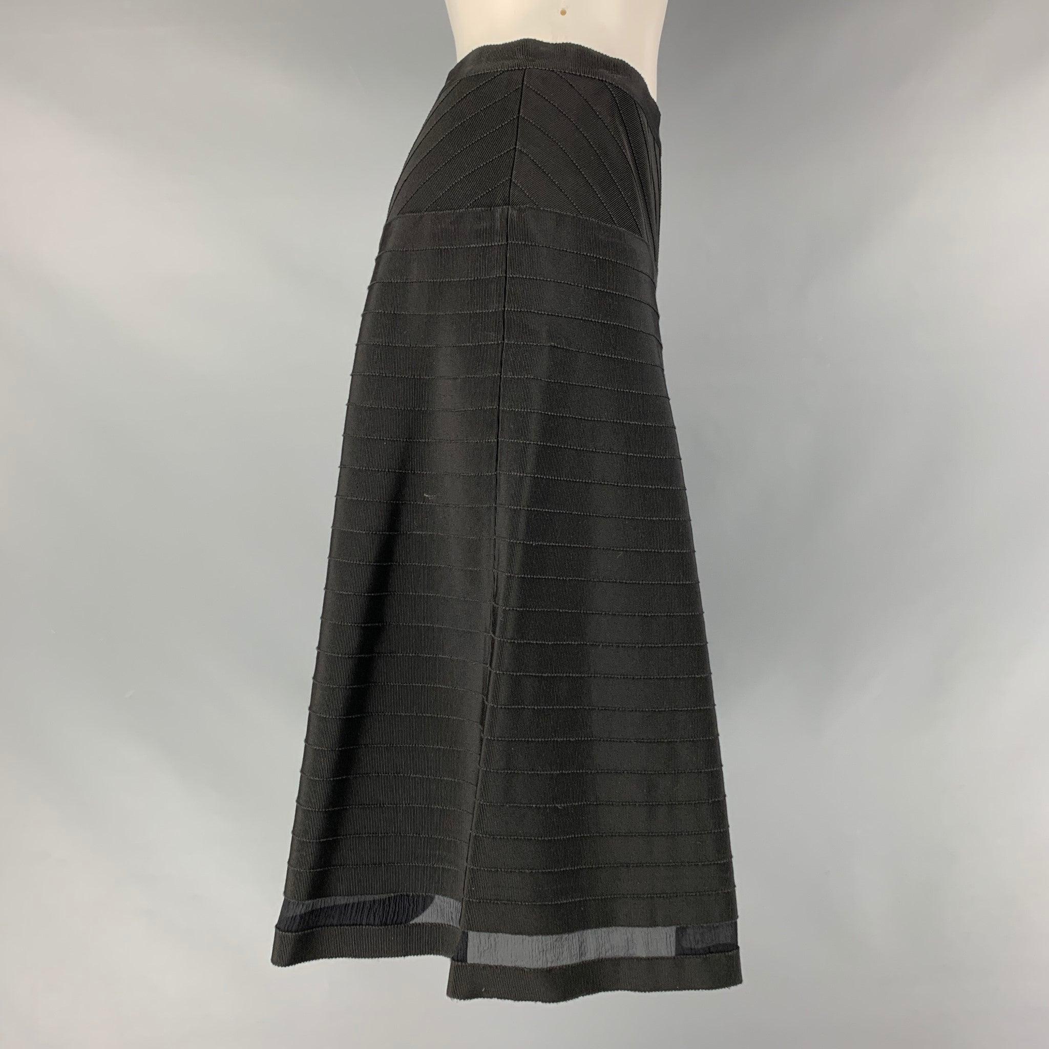 PRADA a-line skirt comes in a black cotton and viscose material featuring a rib texture and a side invisible zip up closure. Made in Italy. Very Good Pre-Owned Condition. Minor mark at back. 

Marked:   38 

Measurements: 
  Waist: 27 inches Hip: 36