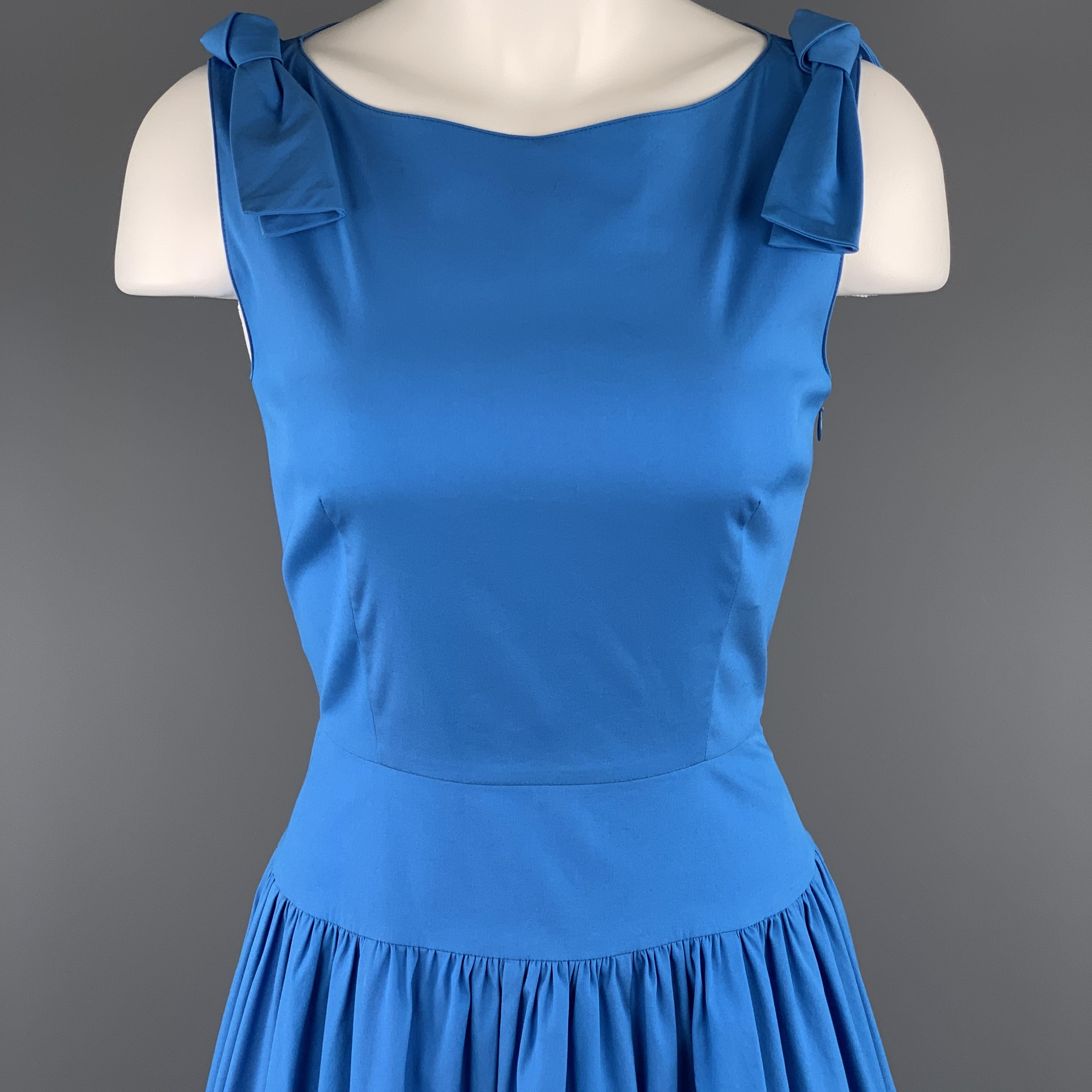 Sleeveless PRADA sun dress comes in blue stretch cotton with a boat neck, bow accents, thick waistband, and gathered full skirt. 

Excellent Pre-Owned Condition.
Marked: IT 38

Measurements:

Shoulder: 14 in.
Bust: 36 in.
Waist: 25 in.
Hip: 44
