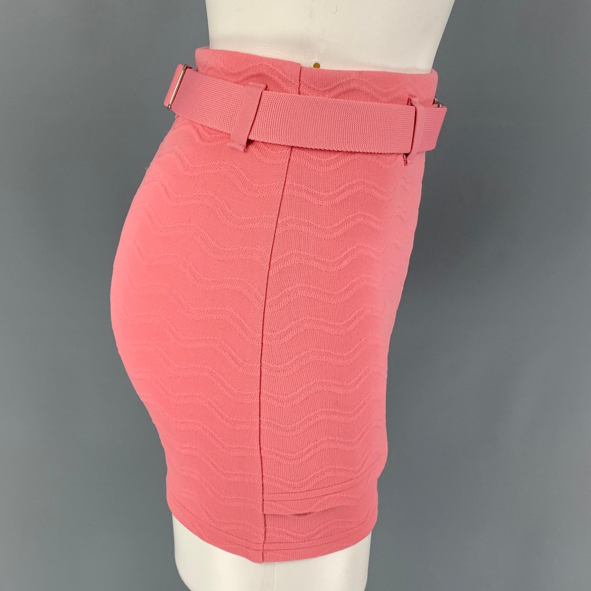 PRADA skirt comes in a pink jacquard polyester blend featuring a shorts style underlay, belt loops, adjustable belt, logo engraved silver tone hardware, and a side zipper closure. Made in Italy. 

Excellent Pre-Owned Condition.
Marked: 38
Original
