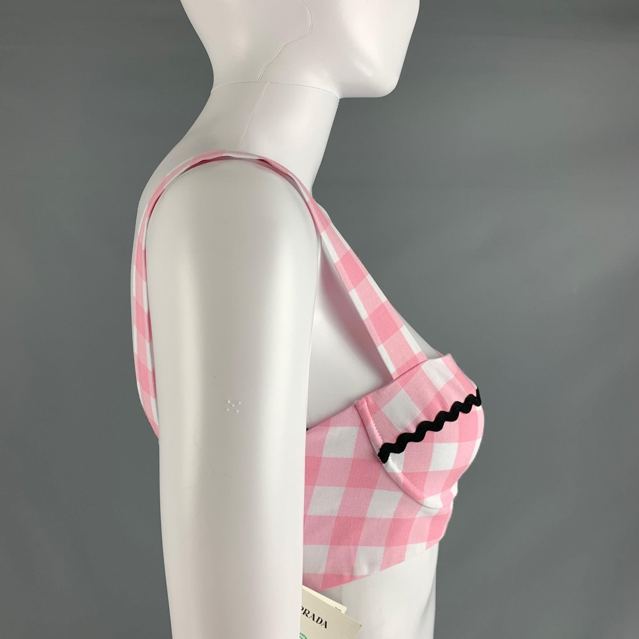 PRADA crop top comes in pink and white gingham cotton woven material featuring a cropped length, black ribbon details, and a pink zip up closure. Made in Italy. New with Tags. 

Marked:   38 

Measurements: 
  Bust: 29 inches Length:
 inches  
  
 