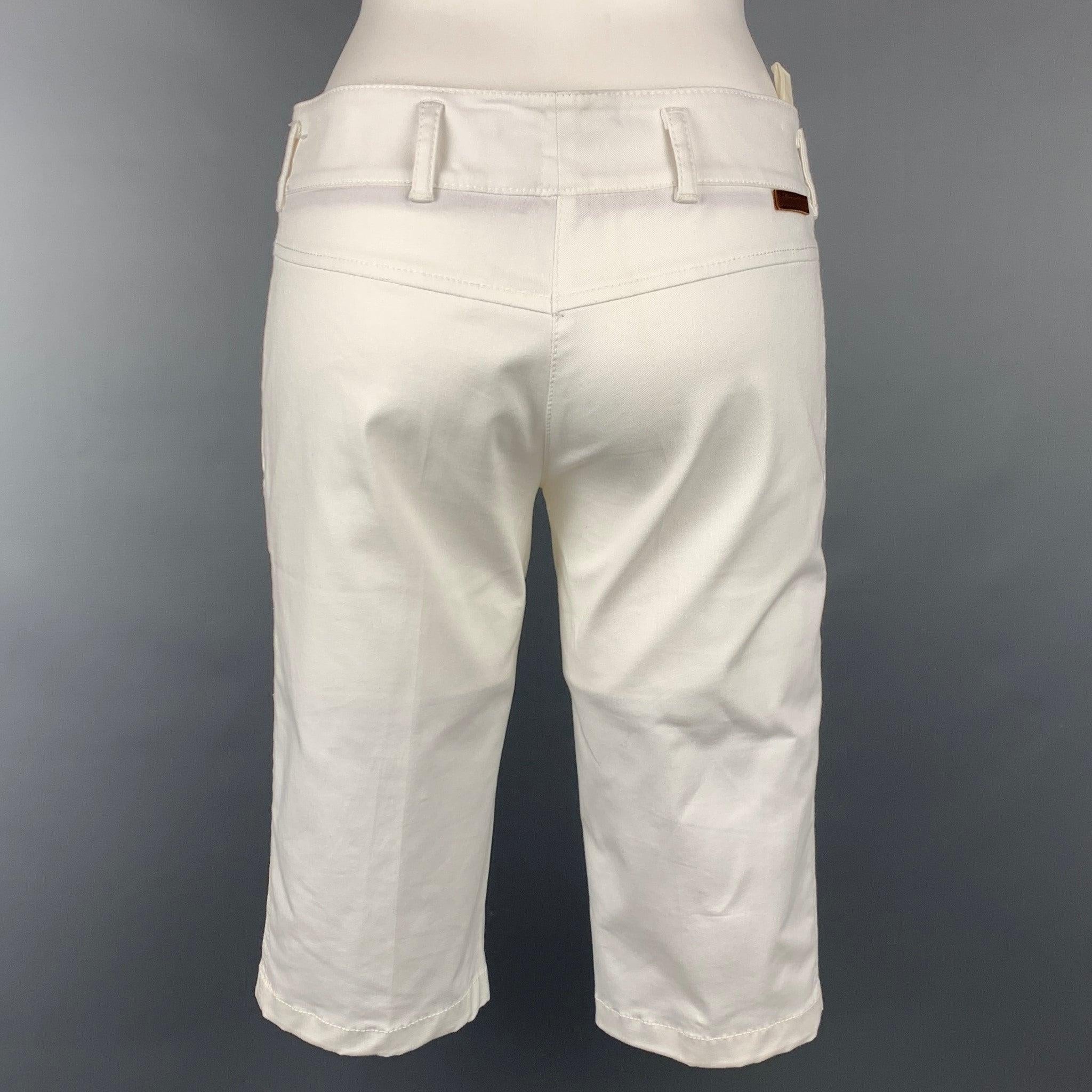 PRADA shorts comes in a white cotton blend featuring a bermuda style, zip fly, and a front tab closure.
Very Good
Pre-Owned Condition. 

Marked:   38 

Measurements: 
  Waist: 30 inches  Rise: 8 inches  Inseam: 14 inches 
  
  
 
Reference: