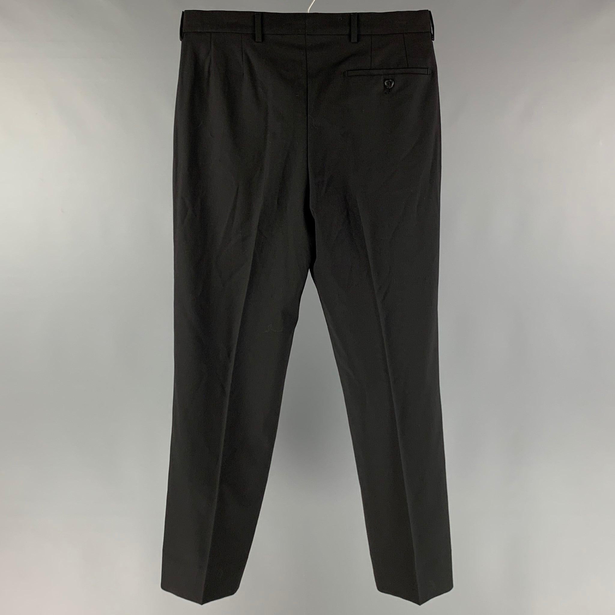 PRADA dress pants comes in a black wool woven material featuring a flat front, front tag, welt pockets, and a zip fly closure. Made in Italy. Very Good Pre-Owned Condition. Altered. 

Marked:  44 

Measurements: 
 Waist: 32 inches Rise: 10 inches