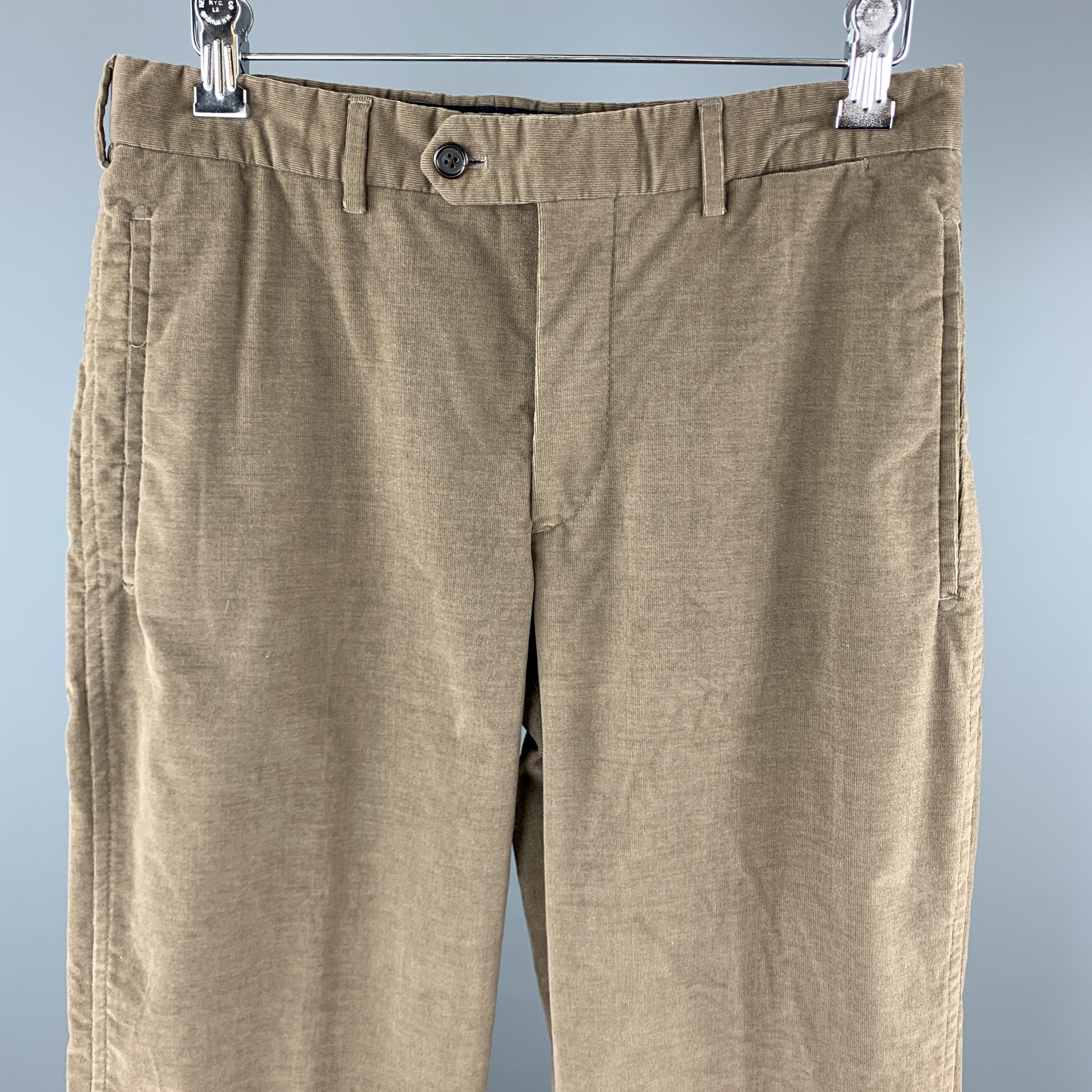 PRADA chino cut pants come in taupe corduroy with a straight leg, zip fly, and tab waistband. Made in Italy.

Very Good Pre-Owned Condition.
Marked: IT 46

Measurements:

Waist: 30 in.
Rise: 10 in.
Inseam: 31 in.