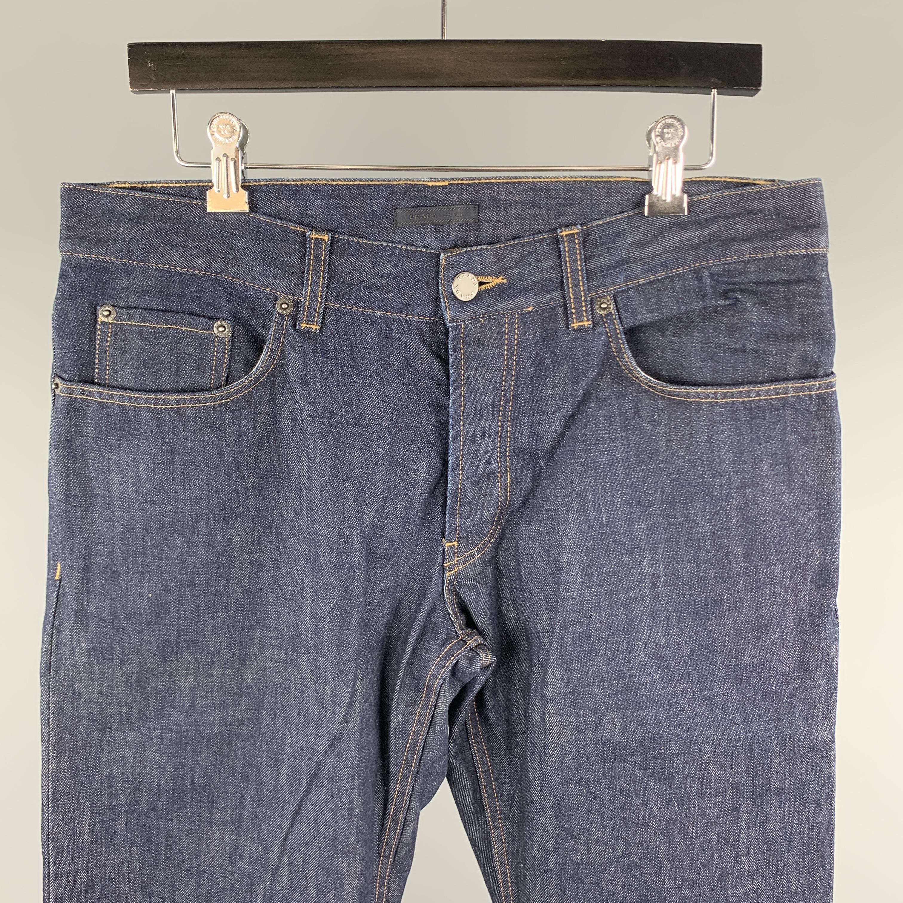 PRADA jeans comes in a indigo denim featuring a classic fit, contrast stitching, and a button fly closure. Made in Romania.
 

Excellent Pre-Owned Condition.
Marked: 33

Measurements:

Waist: 33 in. 
Rise: 9 in. 
Inseam: 33 in. 