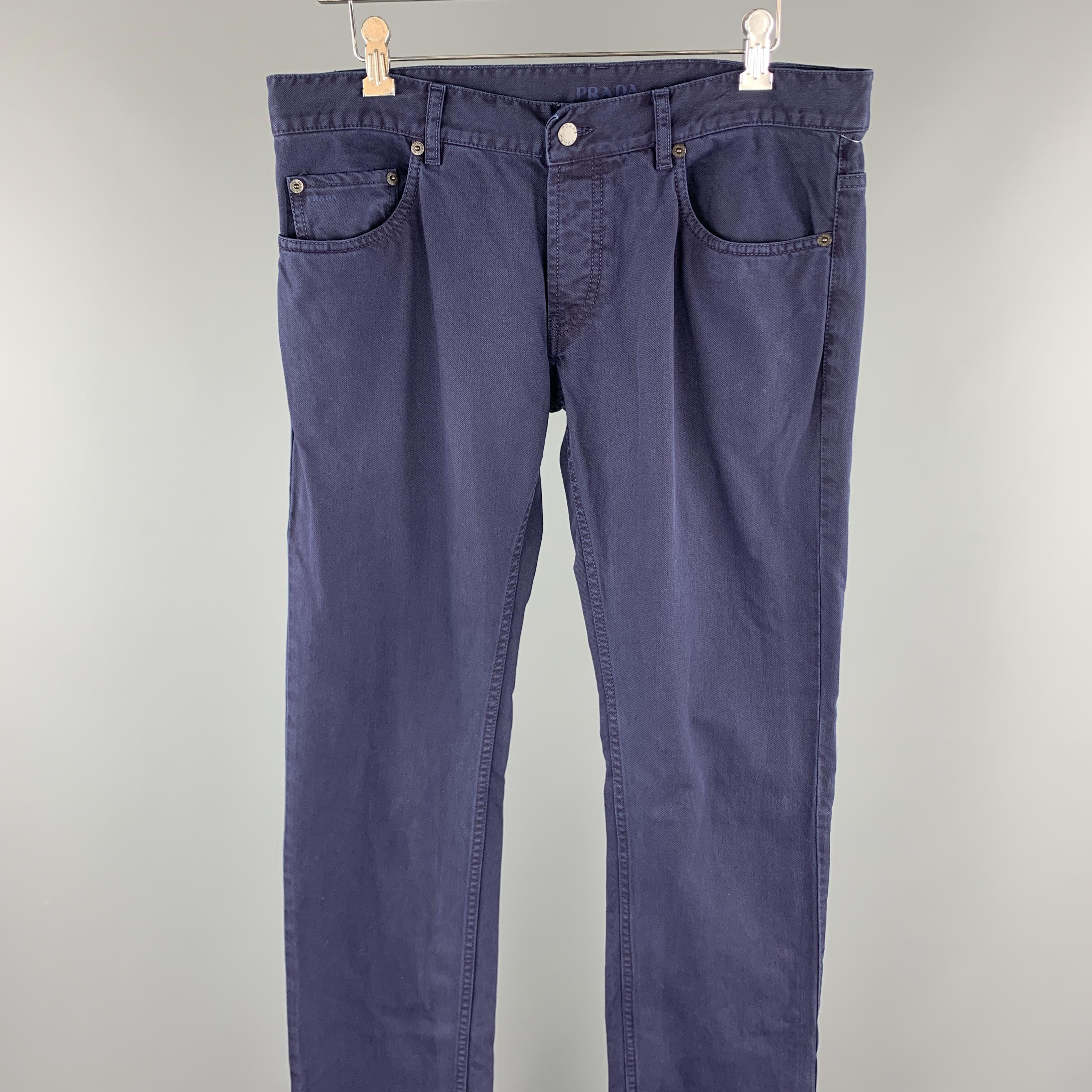 PRADA casual pants comes in a navy cotton featuring a jean cut style and a zip fly closure. 

Very Good Pre-Owned Condition.
Marked: 33

Measurements:

Waist: 34 in.
Rise: 8 in. 
Inseam: 34 in.