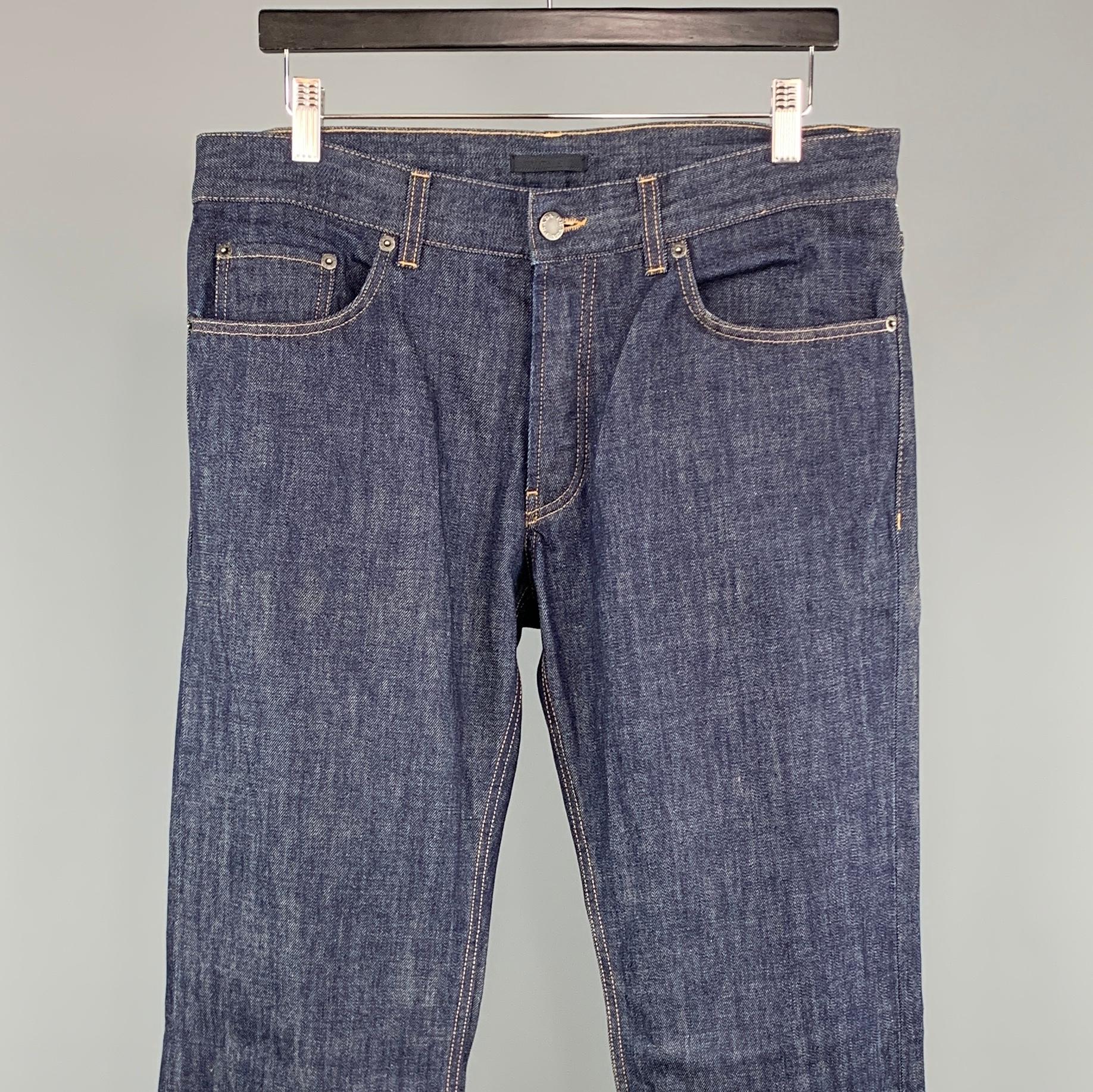 PRADA jeans comes in a indigo cotton featuring a straight leg style, contrast stitching, and a button fly. Made in Romania.
 
Excellent Pre-Owned Condition.
Marked: 33
 
Measurements:
 
Waist: 33 in.
Rise: 8.5 in.
Inseam: 34 in.