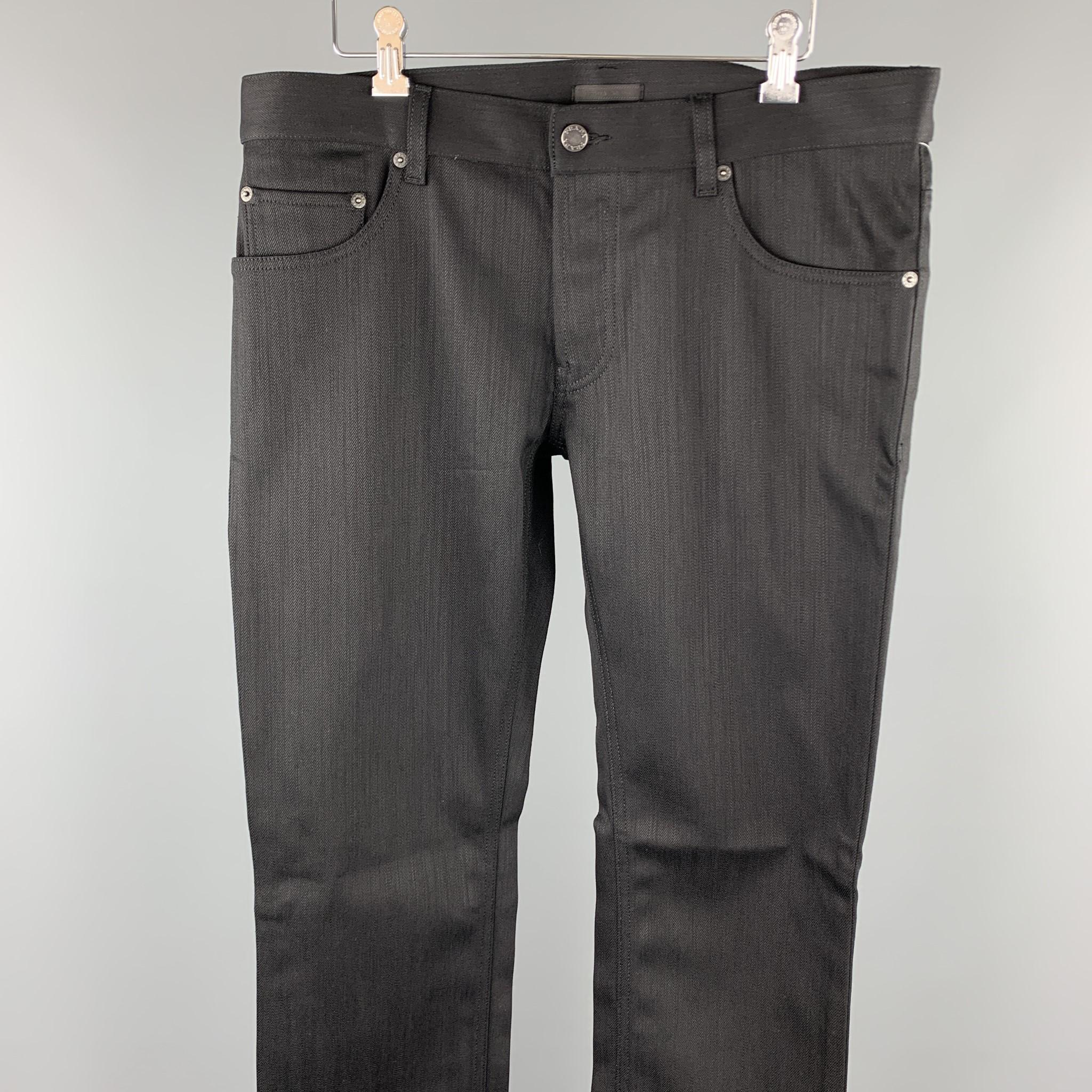 PRADA jeans comes in a black cotton / polyurethane featuring a tight fit and a button fly. Made in Romania.

New With Tags.
Marked: 34

Measurements:

Waist: 36 in.
Rise: 8 in. 
Inseam: 34 in. 

