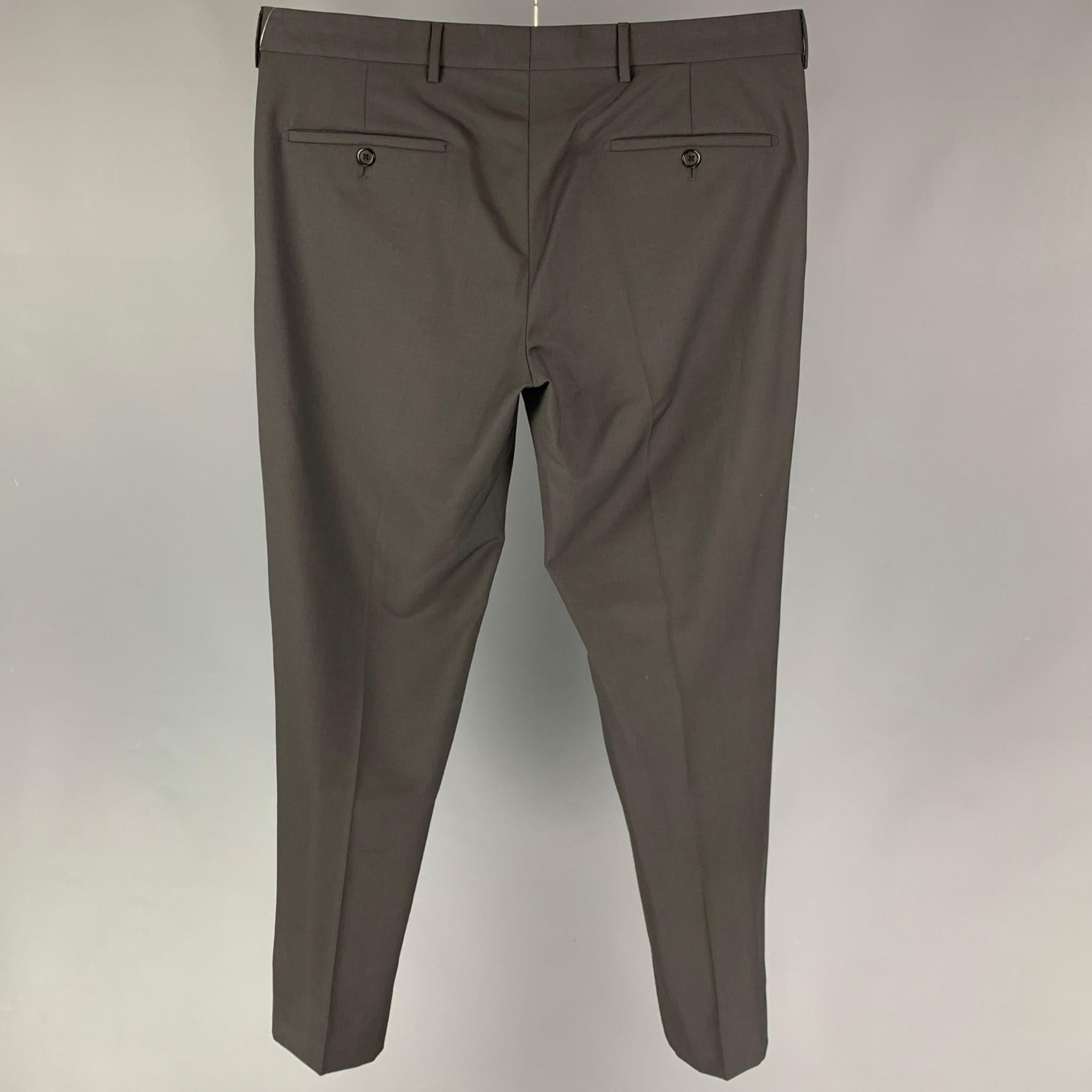 PRADA dress pants comes in a charcoal wool  featuring a flat front, front tab, and a button fly closure. Made in Italy. 

Very Good Pre-Owned Condition.
Marked: 50

Measurements:

Waist: 34 in.
Rise: 10 in.
Inseam: 30 in. 