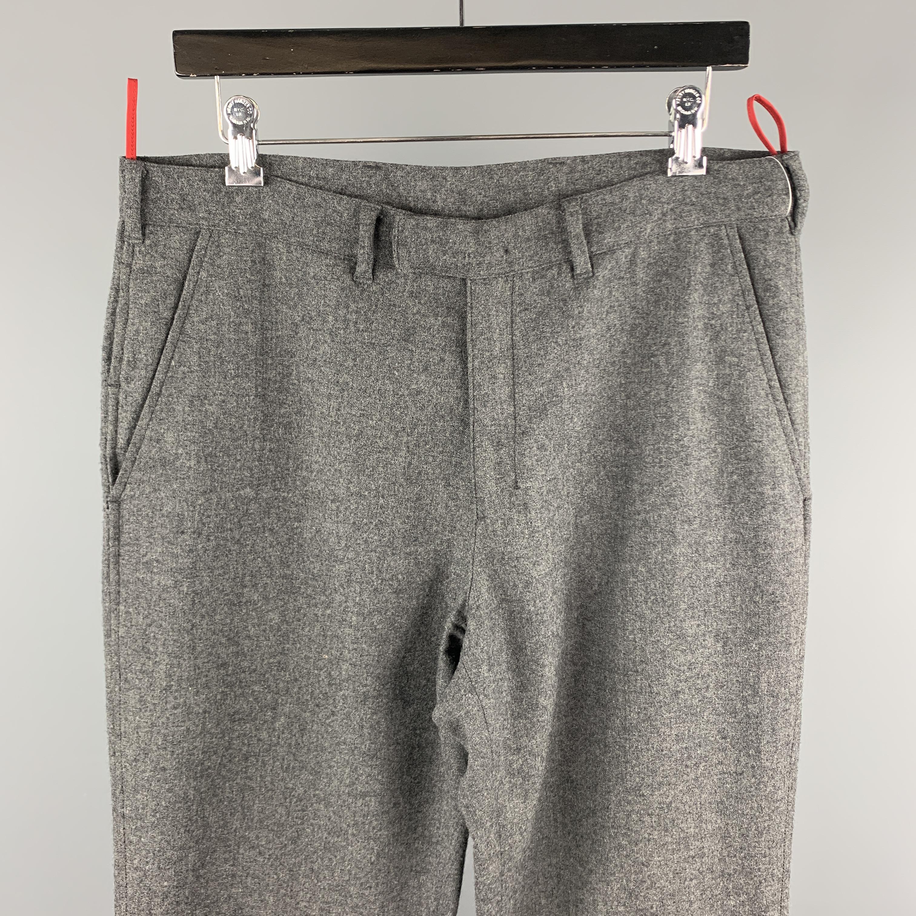 PRADA casual pants comes in a gray wool blend featuring a regular fit, front tab, and a zip fly closure. Made in Italy.  

Excellent Pre-Owned Condition.
Marked: IT 50

Measurements:

Waist: 34 in. 
Rise: 10 in. 
Inseam: 34 in. 