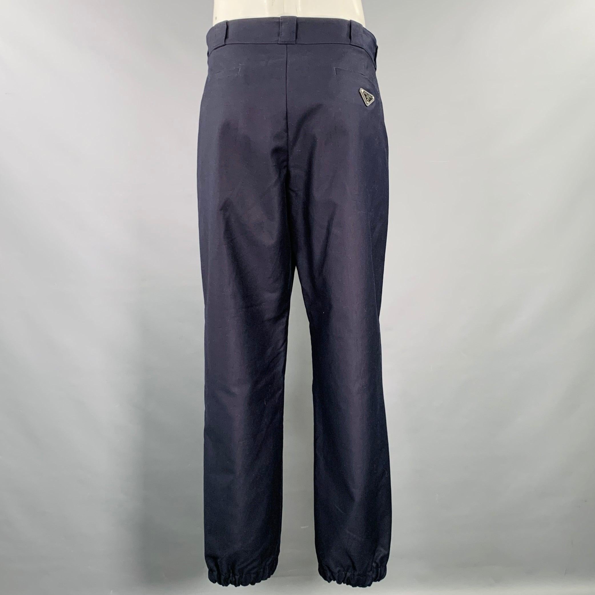 PRADA casual pants
in a navy cotton twill featuring a flat front style, elastic cuffs, and zip fly closure. Made in Italy.Excellent Pre-Owned Condition. 

Marked:   IT 50 

Measurements: 
  Waist: 34 inches Rise: 11.5 inches Inseam: 32 inches 
  
 