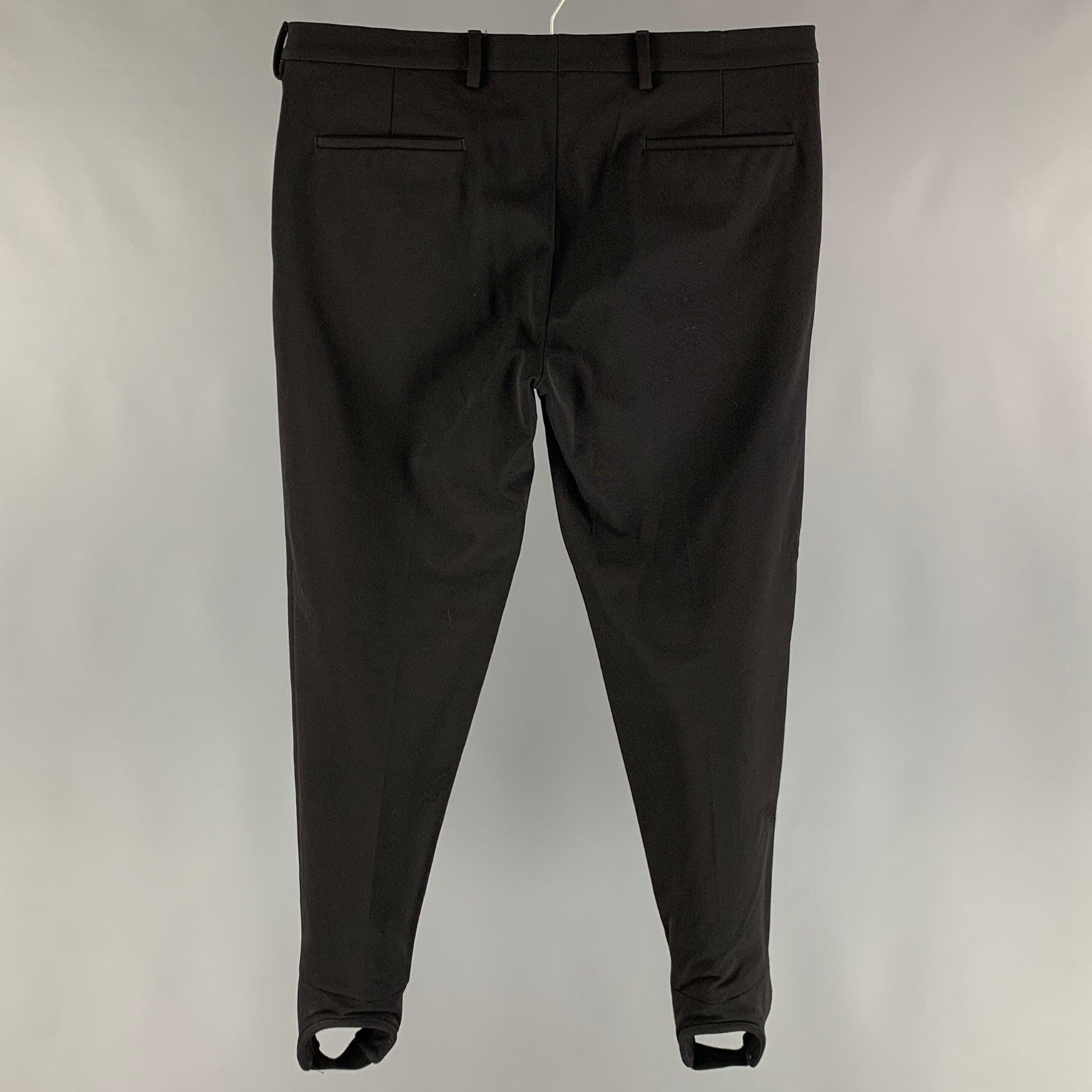 PRADA 2007 dress pants comes in a black nylon blend fleece material featuring a jodhpurs style, flat front, front tab, and a button closure. Made in Italy. Very Good Pre-Owned Condition. As- Is. 

Marked:  52 

Measurements: 
 Waist: 37 inches Rise: