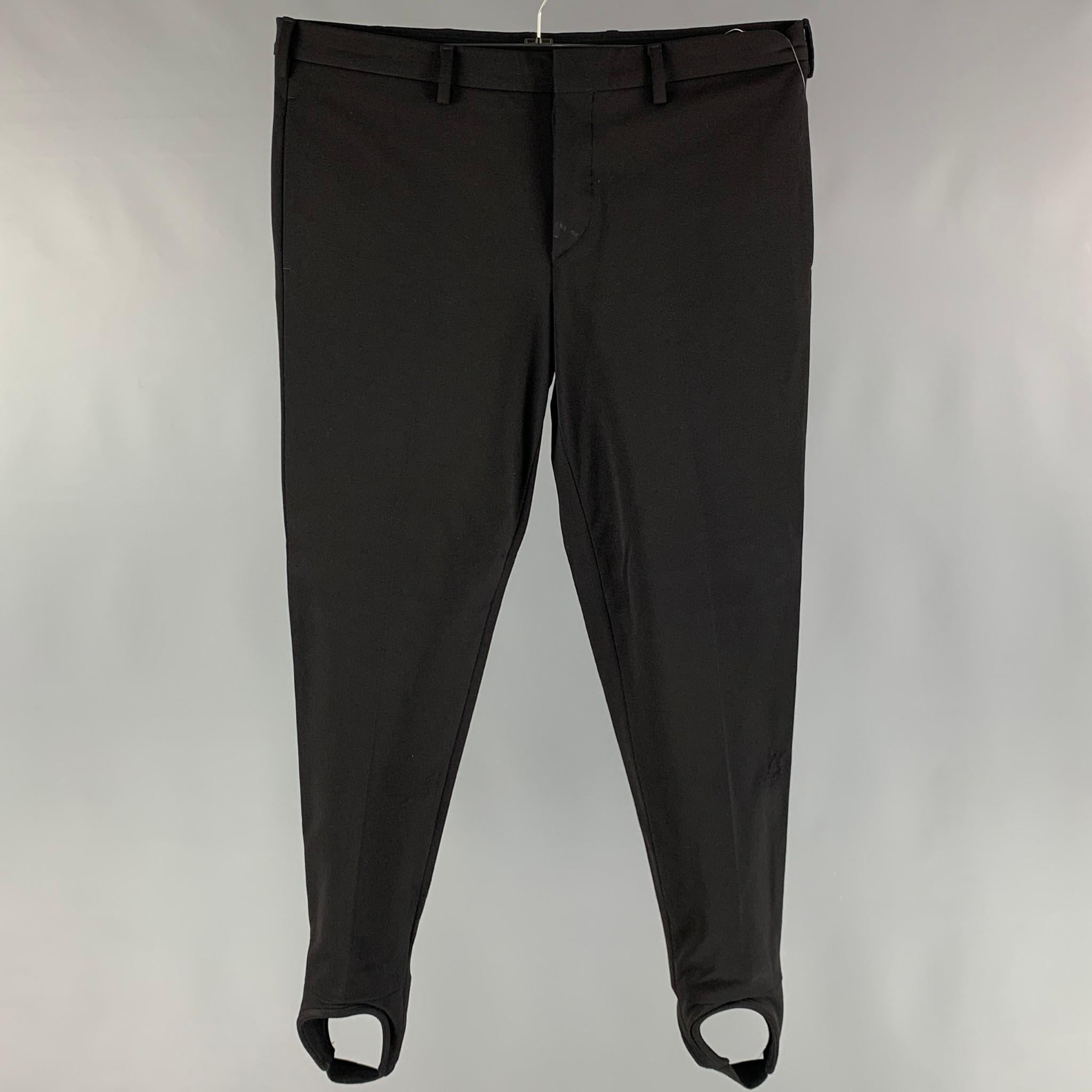 PRADA 2007 dress pants comes in a black nylon blend fleece material featuring a jodhpurs style, flat front, front tab, and a button closure. Made in Italy.

Very Good Pre-Owned Condition. As- Is.
Marked: 52

Measurements:

Waist: 37 in.
Rise: 9.5