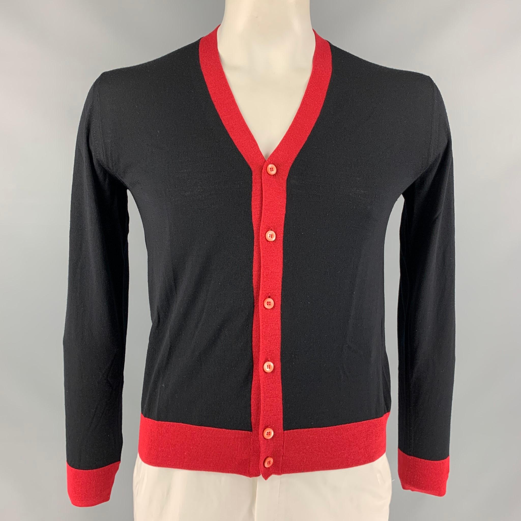 PRADA V- neck cardigan comes in black and red color block knit fabric. Made in Italy.

Very Good Pre-Owned Condition.
Marked: 46

Measurements:

Shoulder: 18 in.
Chest: 44 in.
Sleeve: 24.5 in.
Length: 25 in.   

 

SKU: 113562
Category: