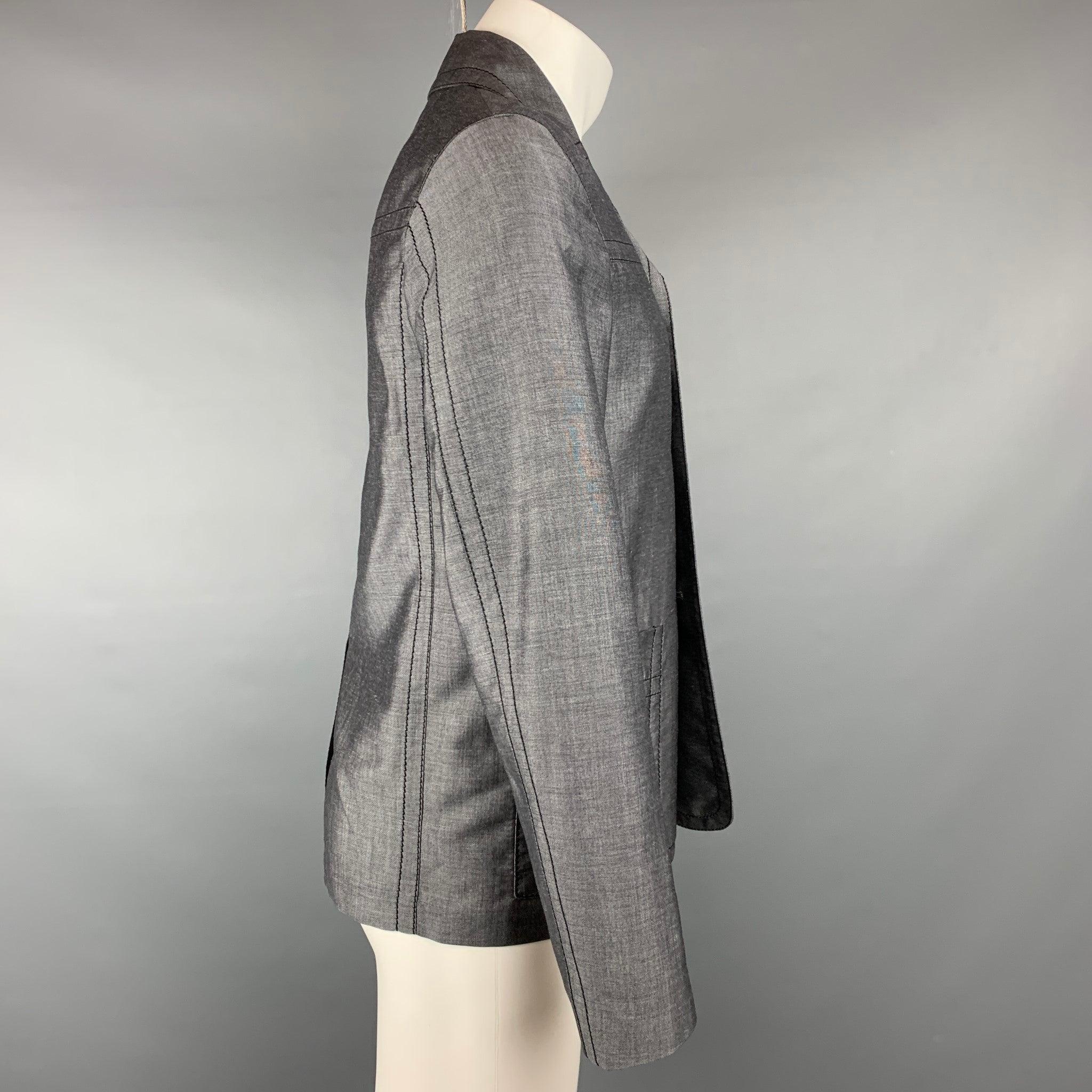PRADA jacket comes in a dark gray mohair / wool featuring a notch lapel, contrast stitching, patch pockets, and a buttoned closure. Made in Italy.Very Good
Pre-Owned Condition. 

Marked:   IT 46 

Measurements: 
 
Shoulder: 16.5 inches  Chest: 38