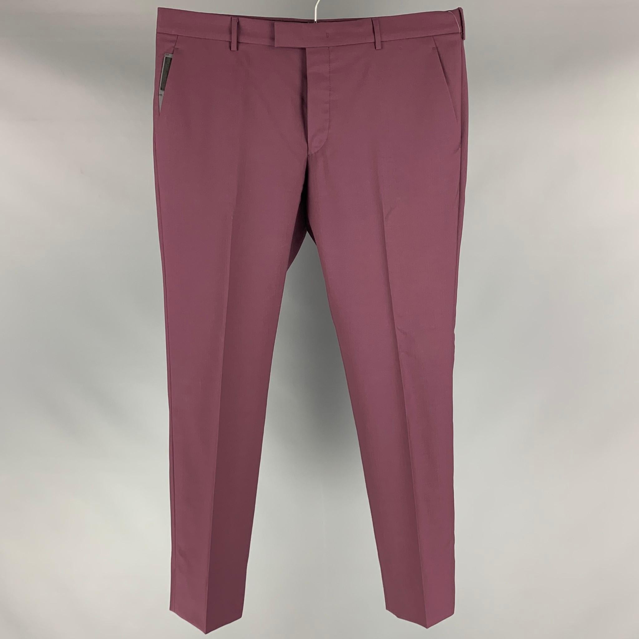 PRADA dress pants comes in purple mohair and wool featuring a flat front, front tab, and a zip fly closure. Made in Italy.

Excellent Pre-Owned Condition.
Marked: 52

Measurements:

Waist: 38 in.
Rise: 10 in.
Inseam: 32 in.
Leg Opening: 15 in. 

