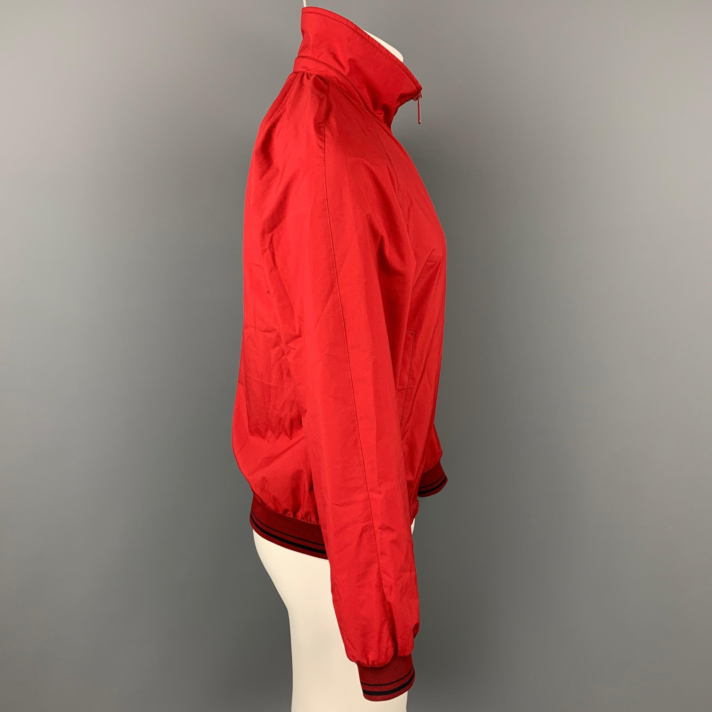 PRADA jacket comes in a red polyester with a mesh liner featuring a windbreaker style, ribbed hem, front logo, and a zip up closure.Good
 Pre-Owned Condition. 
 

 Marked:  46 
 

 Measurements: 
  
 Shoulder: 17 inches Chest: 41 inches Sleeve: 25.5