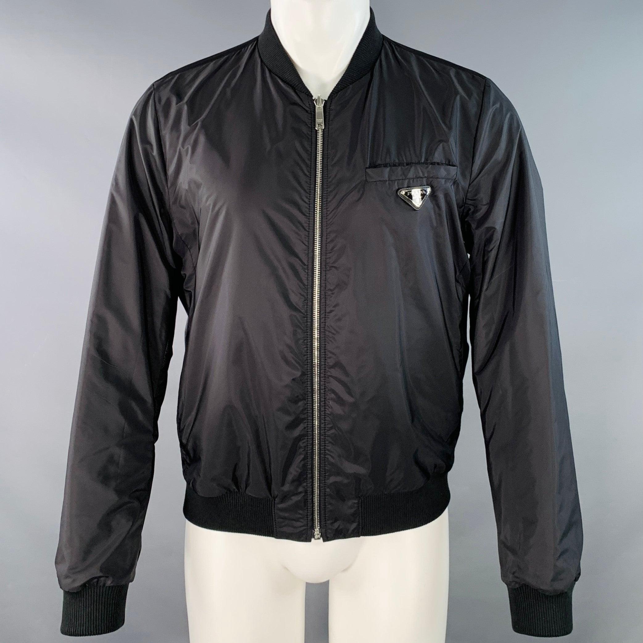 PRADA bomber jacket
in a black lambskin leather and nylon featuring a reversible style, two slip pockets, and zip up closure. Excellent Pre-Owned Condition. 

Marked:   IT 48 

Measurements: 
 
Shoulder: 16 inches Chest: 43 inches Sleeve: 26.5