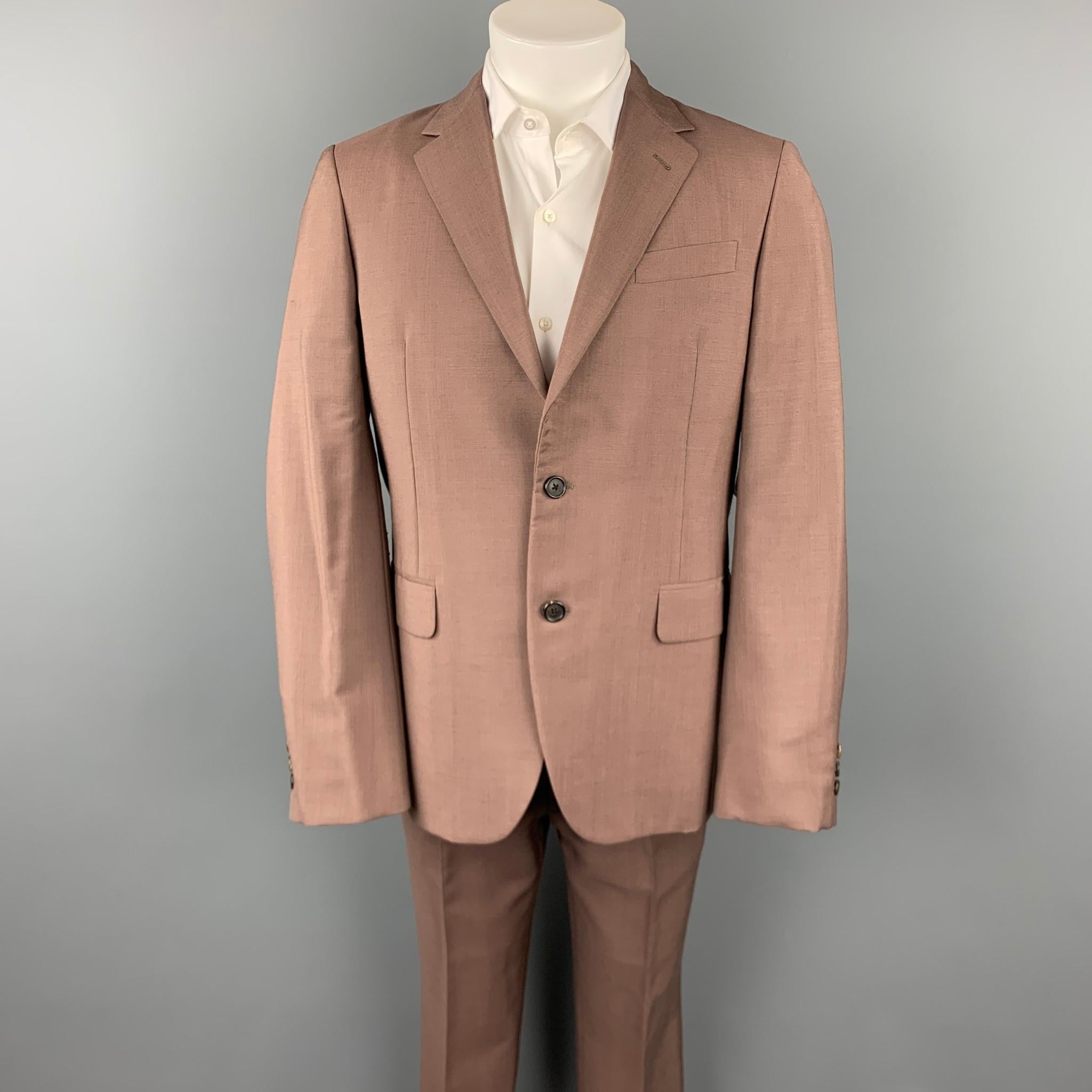 PRADA suit comes in a brown mohair / wool with a full liner and includes a single breasted, two button sport coat with a notch lapel and matching flat front trousers. Moderate discoloration. Made in Italy.

Good Pre-Owned Condition.
Marked: IT 48 R