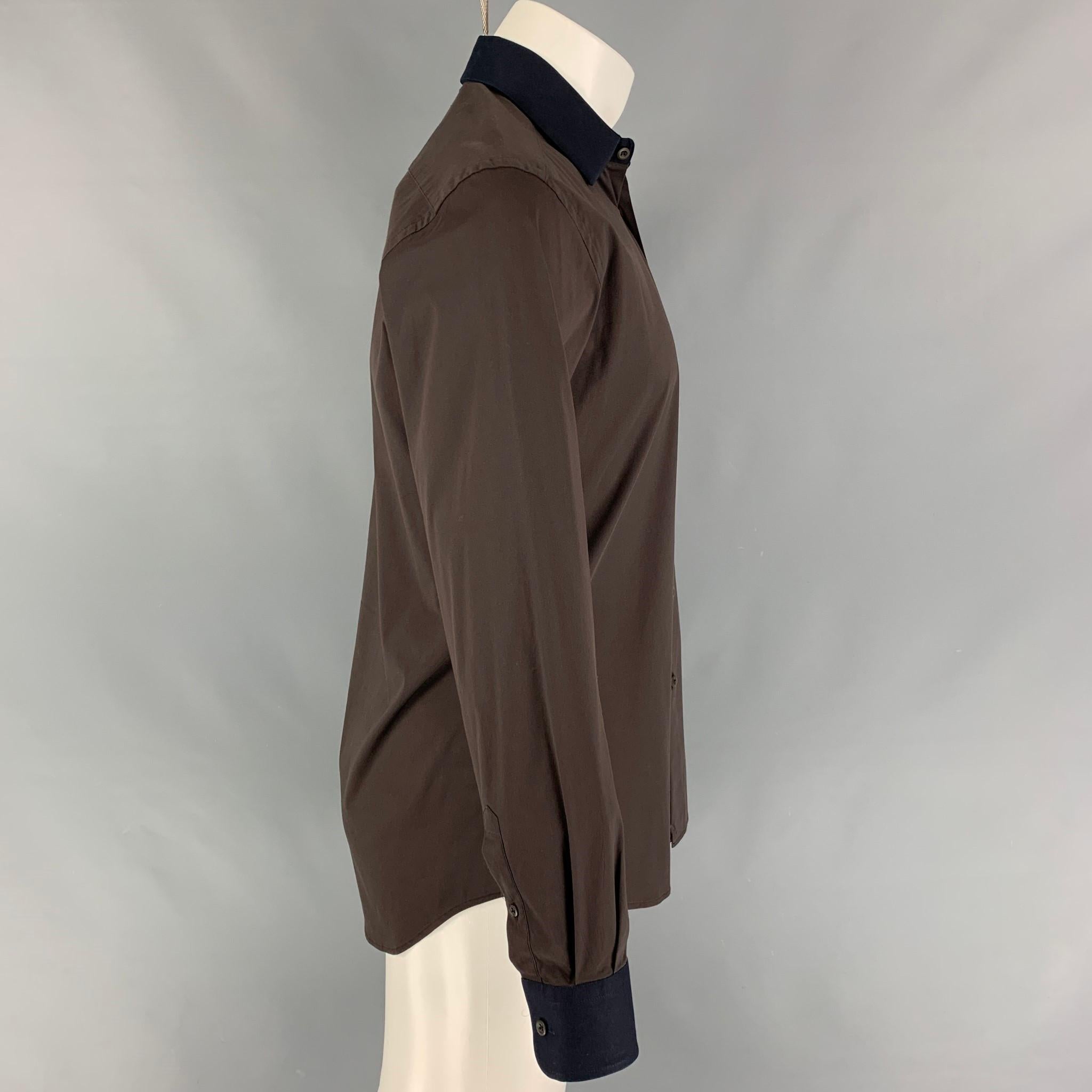 PRADA long sleeve shirt comes in a brown cotton blend with a navy spread collar featuring a button up closure. Made in Italy. 

Very Good Pre-Owned Condition.
Marked: 38/15

Measurements:

Shoulder: 18.5 in.
Chest: 42 in.
Sleeve: 25 in.
Length: 30