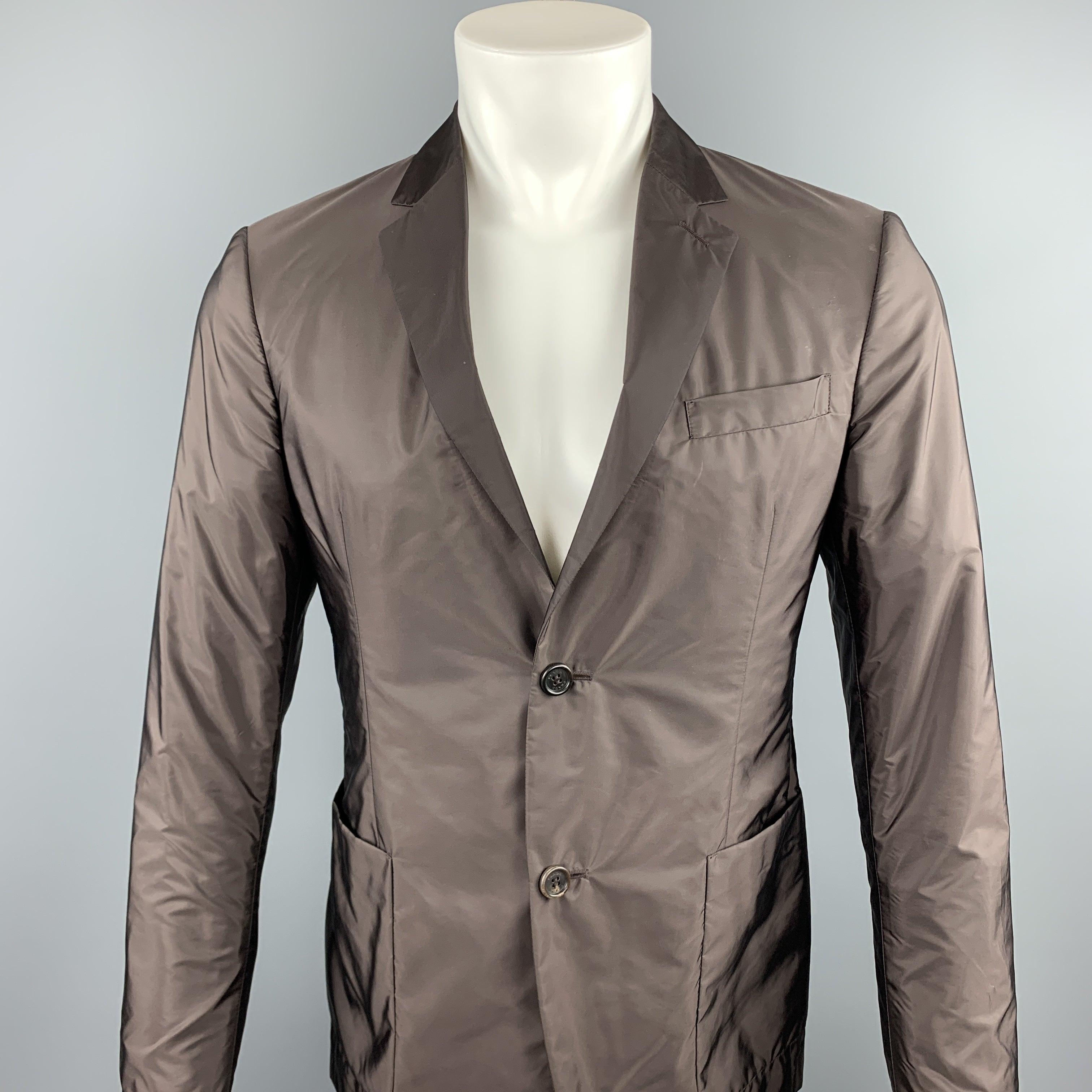PRADA sport coat comes in a brown polyester featuring a notch lapel, patch pockets, and a two button closure.
Excellent
Pre-Owned Condition. 

Marked:   TG 48 

Measurements: 
 
Shoulder: 16.5 inches 
Chest: 38 inches 
Sleeve: 26 inches 
Length: 28