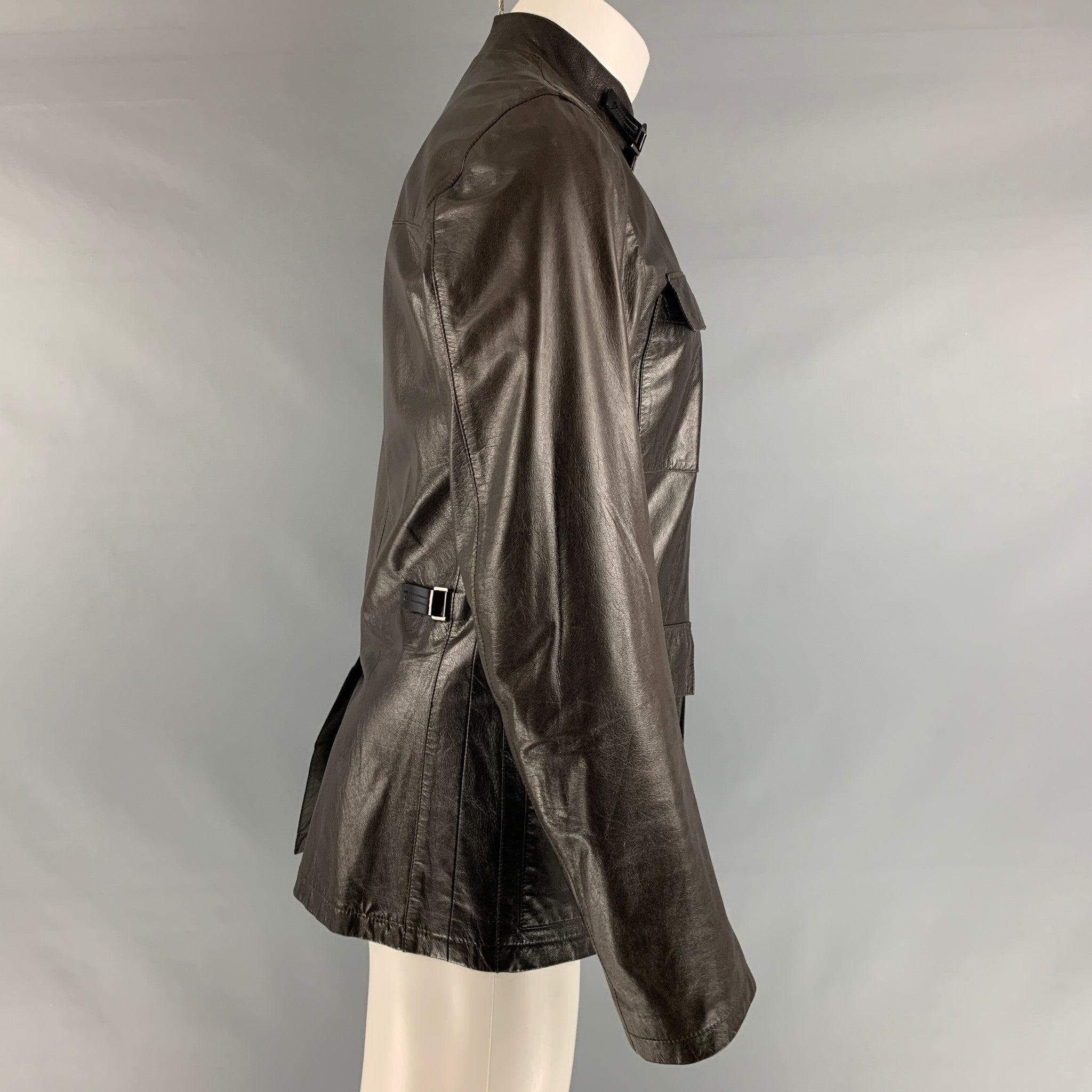 PRADA jacket comes in a brown leather featuring a stand up collar, front pockets, and a zip up closure. Made in Italy.Excellent Pre-Owned Condition. 

Marked:   48 

Measurements: 
 
Shoulder: 18 inches Chest: 43 inches Sleeve: 26 inches Length: 30