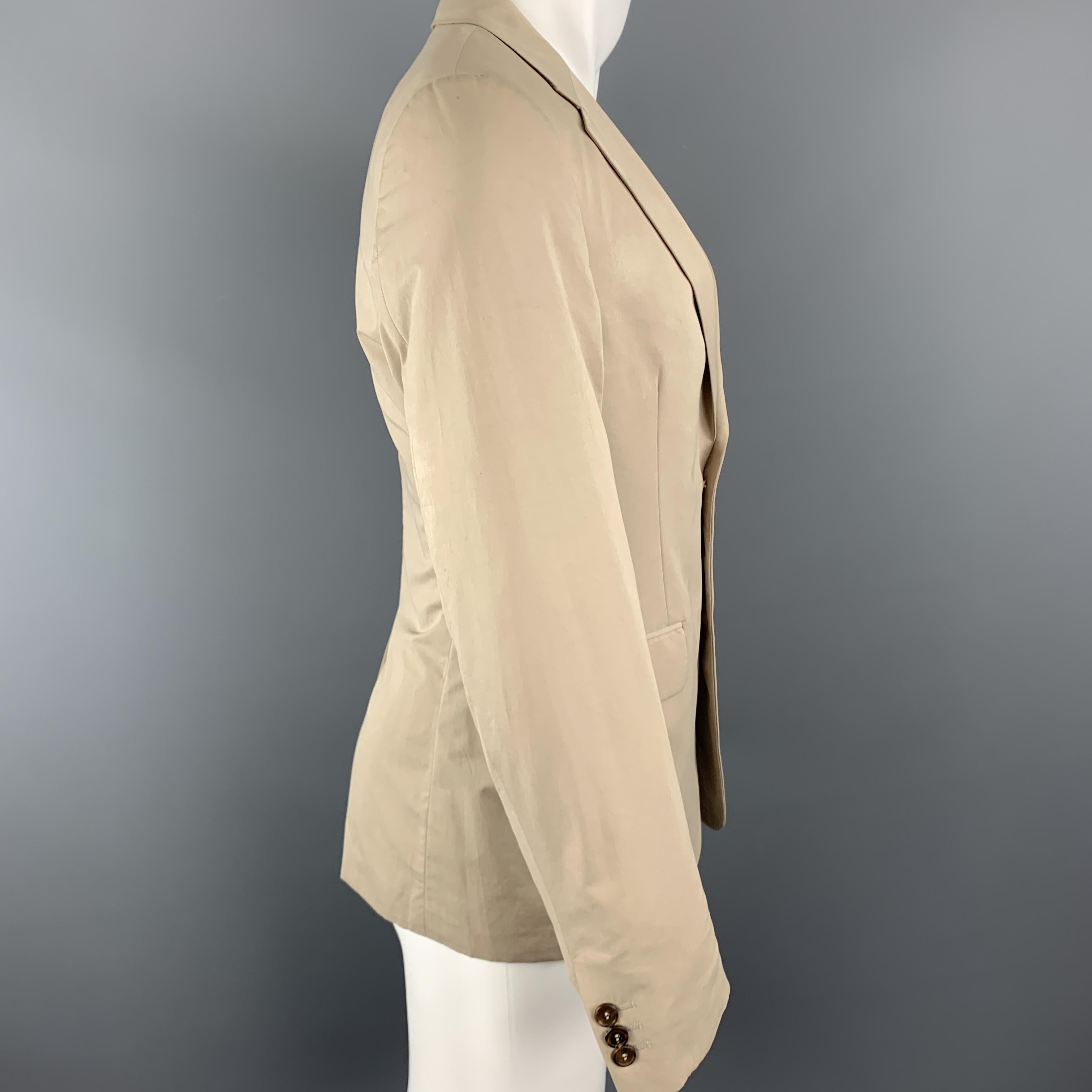 PRADA sport coat comes in khaki beige light weight cotton blend fabric with a notch lapel, single breasted,  two button front, and half liner. Stain on chest. As-is.

Fair Pre-Owned Condition.
Marked: IT 48

Measurements:

Shoulder: 16.5 in.
Chest:
