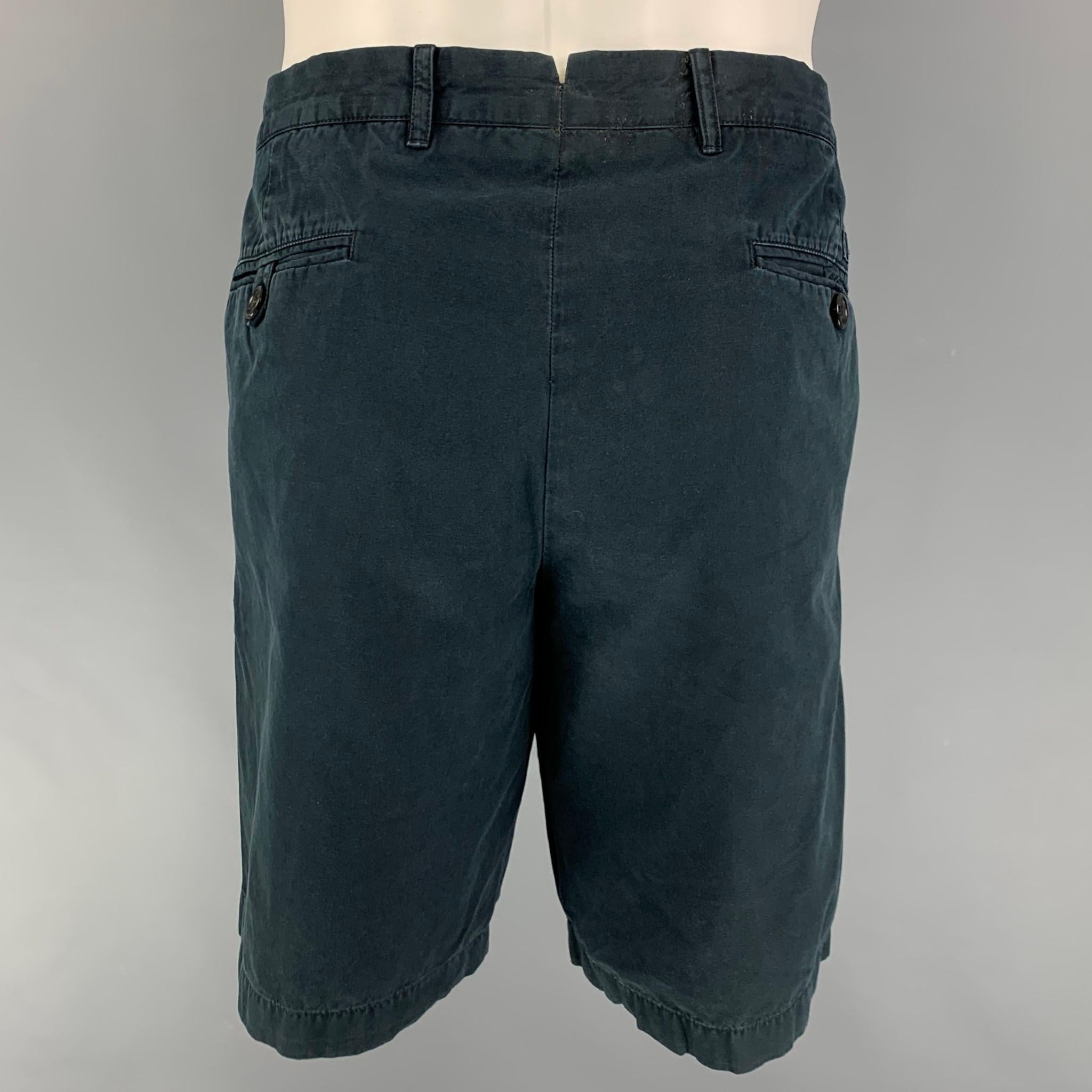 PRADA shorts comes in a navy cotton featuring a zip fly closure. 

Good Pre-Owned Condition. Missing zipper detail. As-Is.
Marked: 54

Measurements:

Waist: 36 in.
Rise: 9.5 in.
Inseam: 10 in. 