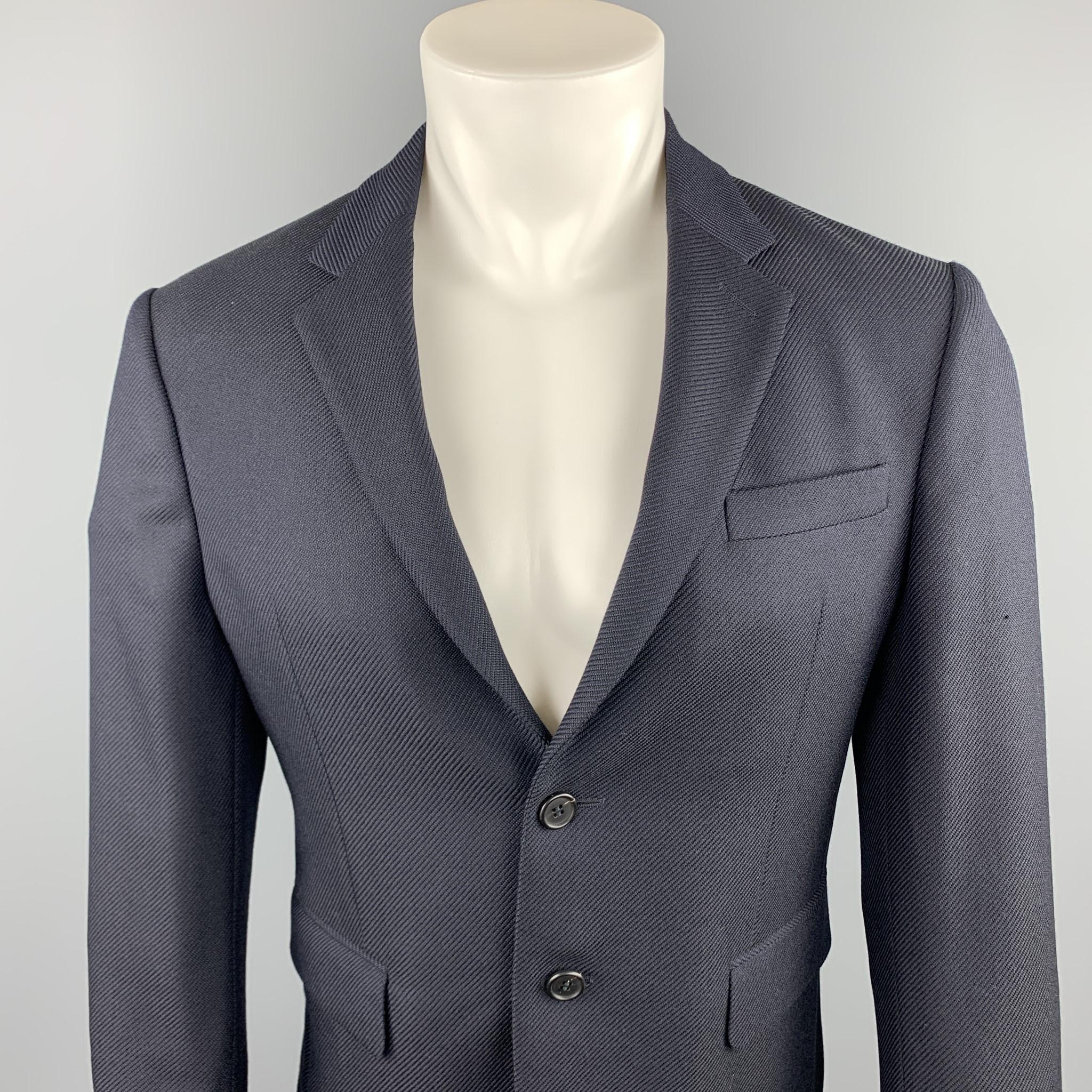 PRADA sport coat comes in a navy textured wool featuring a notch lapel style, flap pockets, and a two button closure.  Sleeves have been professionally altered / shortened.

Excellent Pre-Owned Condition.
Marked: IT 48

Measurements:

Shoulder: 16.5
