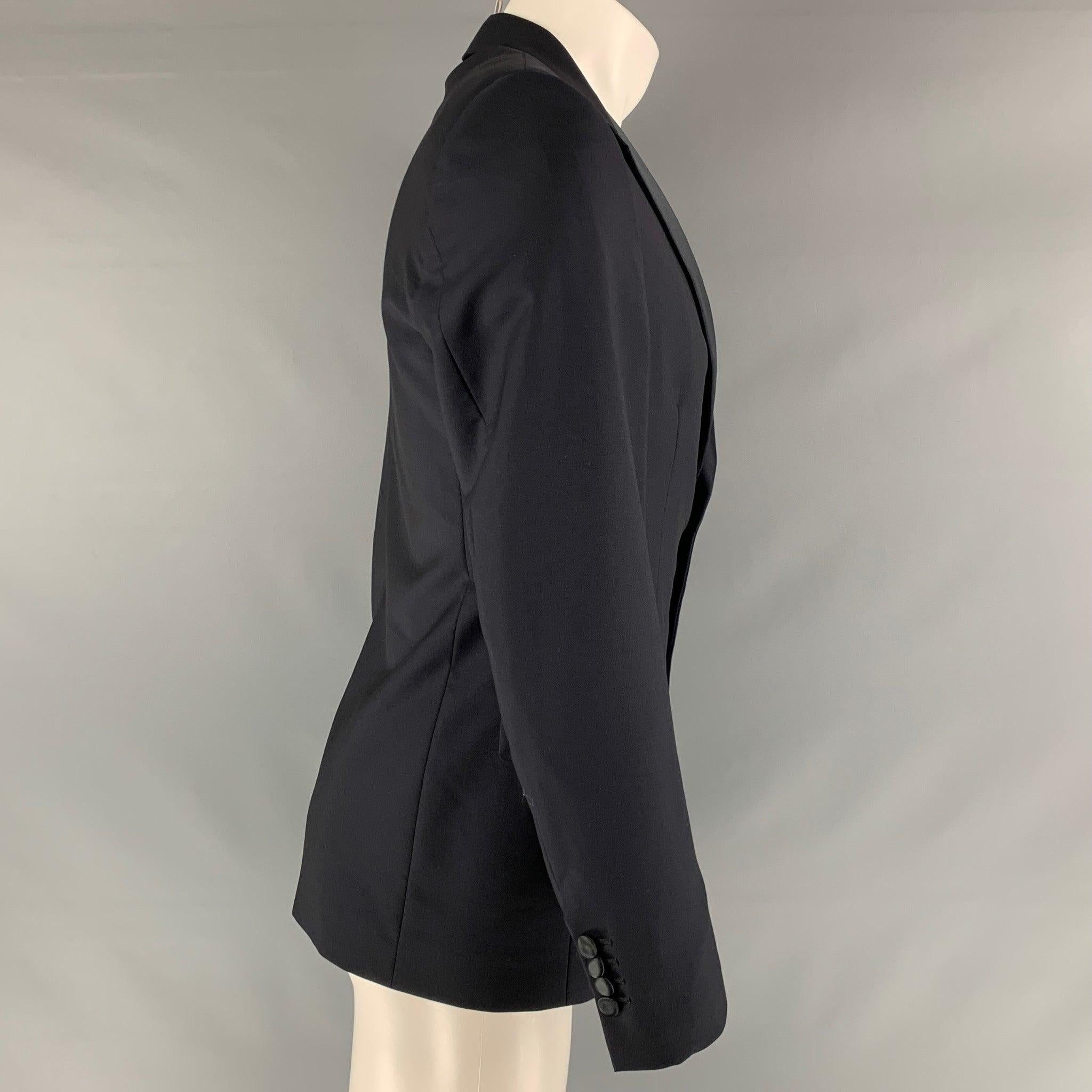 PRADA sport coat comes in a navy wool and mohair woven material featuring a notch lapel, shoulder pockets, flap pockets, and a two button closure. Made in Italy.Excellent Pre-Owned Condition. 

Marked:   48 

Measurements: 
 
Shoulder: 17 inches 