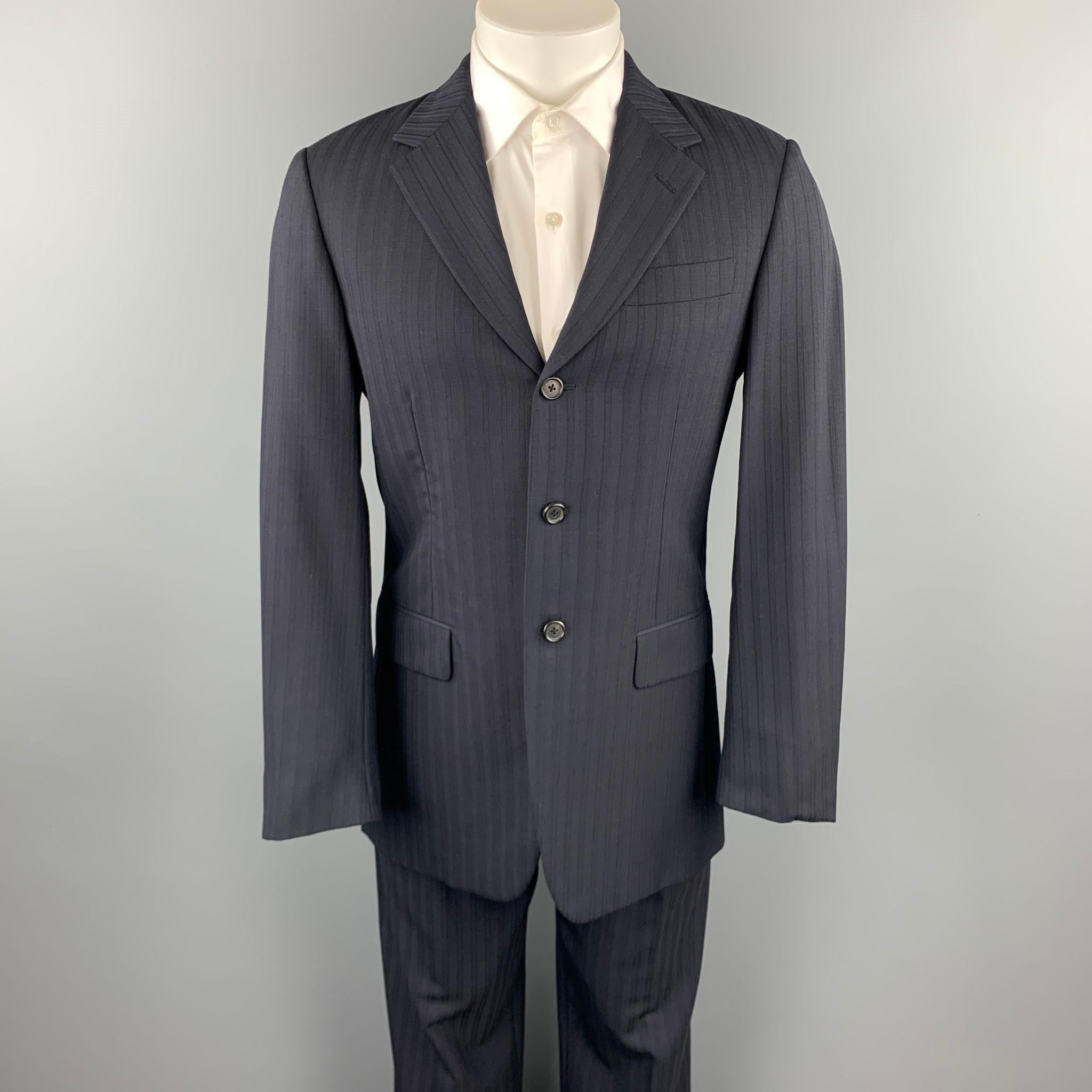 PRADA suit comes in navy stripe wool blend and includes a single breasted, three button sport coat with a notch lapel and matching flat front trousers. Made in Italy.

Very Good Pre-Owned Condition.
Marked: IT 48 R

Measurements:

-Jacket
Shoulder: