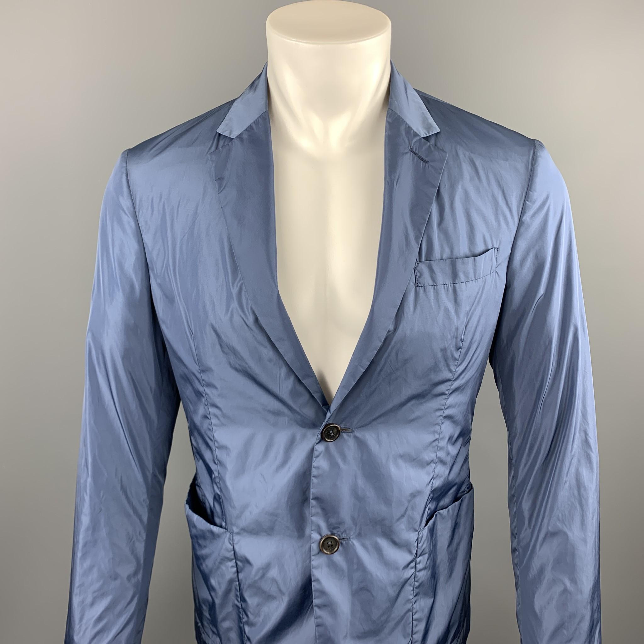 PRADA sport coat comes in a steel blue polyester featuring a notch lapel, patch pockets, and a two button closure. 

Excellent Pre-Owned Condition.
Marked: TG 48

Measurements:

Shoulder: 16.5 in. 
Chest: 38 in.
Sleeve: 26 in.
Length: 28 in.  